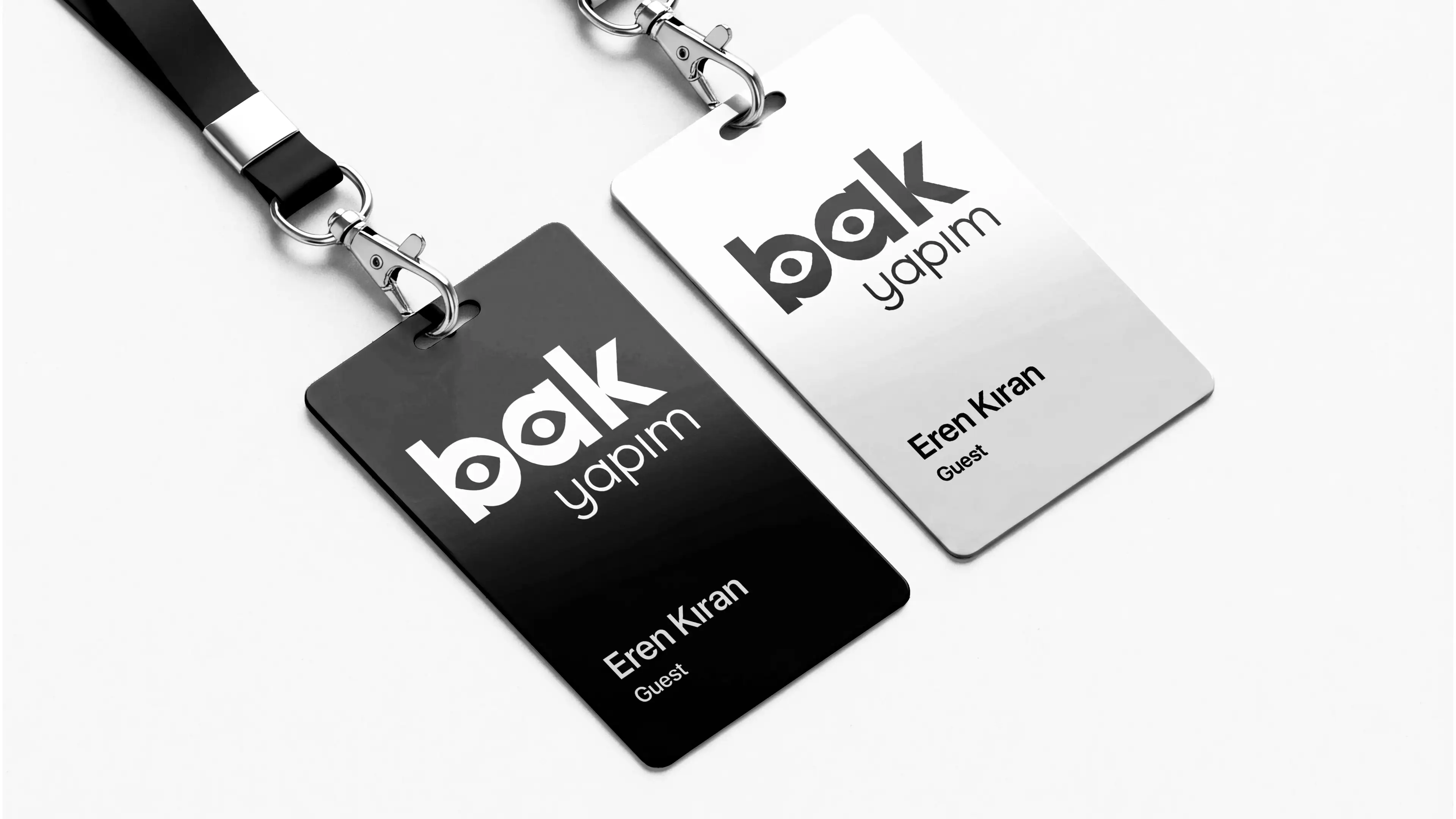 Premium black and white corporate ID cards for staff member Eren Kıran featuring the Bak Yapım logo and professional lanyards.