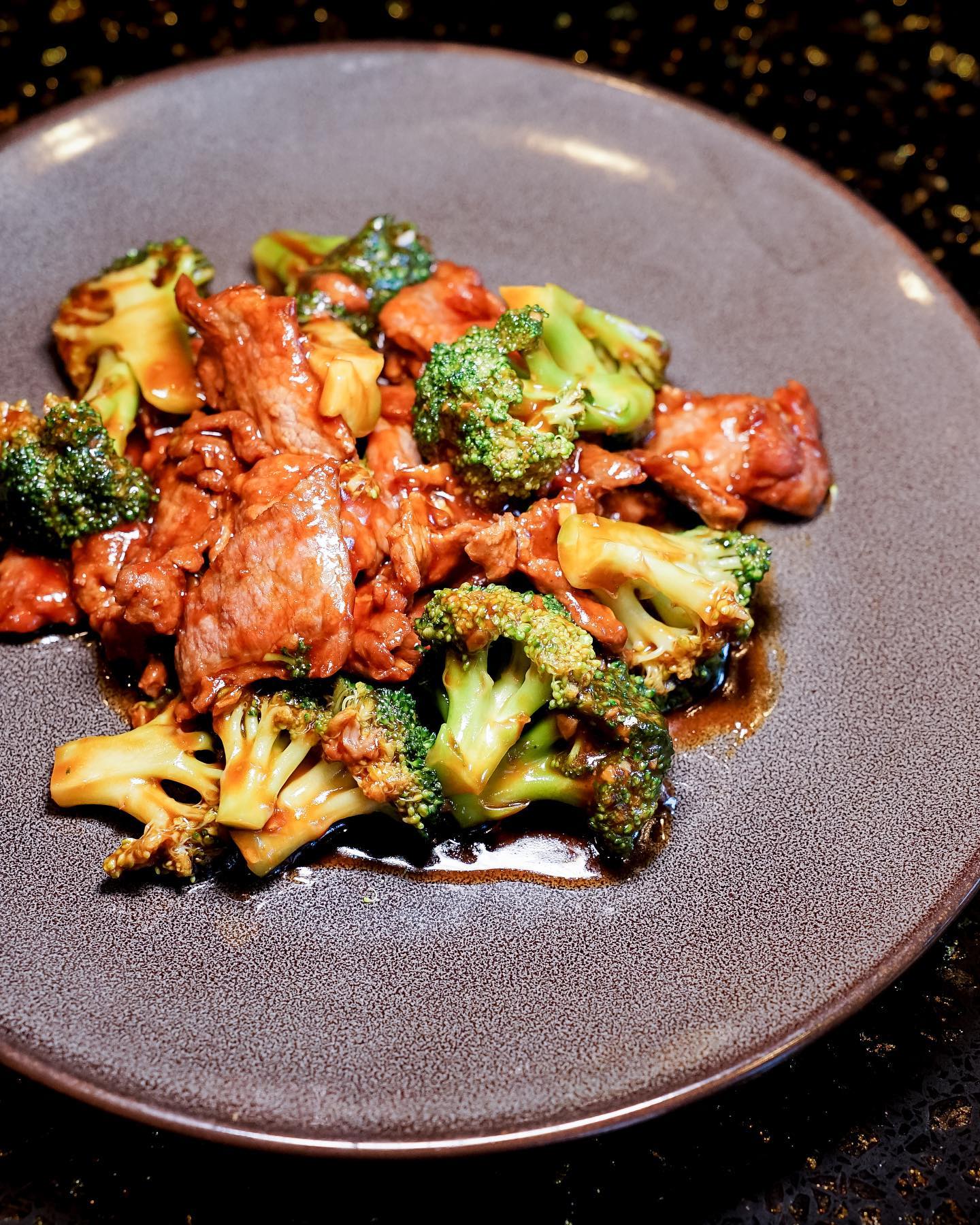 Close-up of Magic Chili Chicken at The Corner, a spicy and crunchy Sichuan-inspired dish garnished with fiery red chilies.