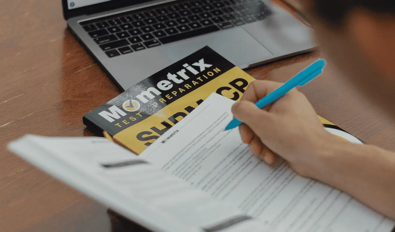 person writing on white paper