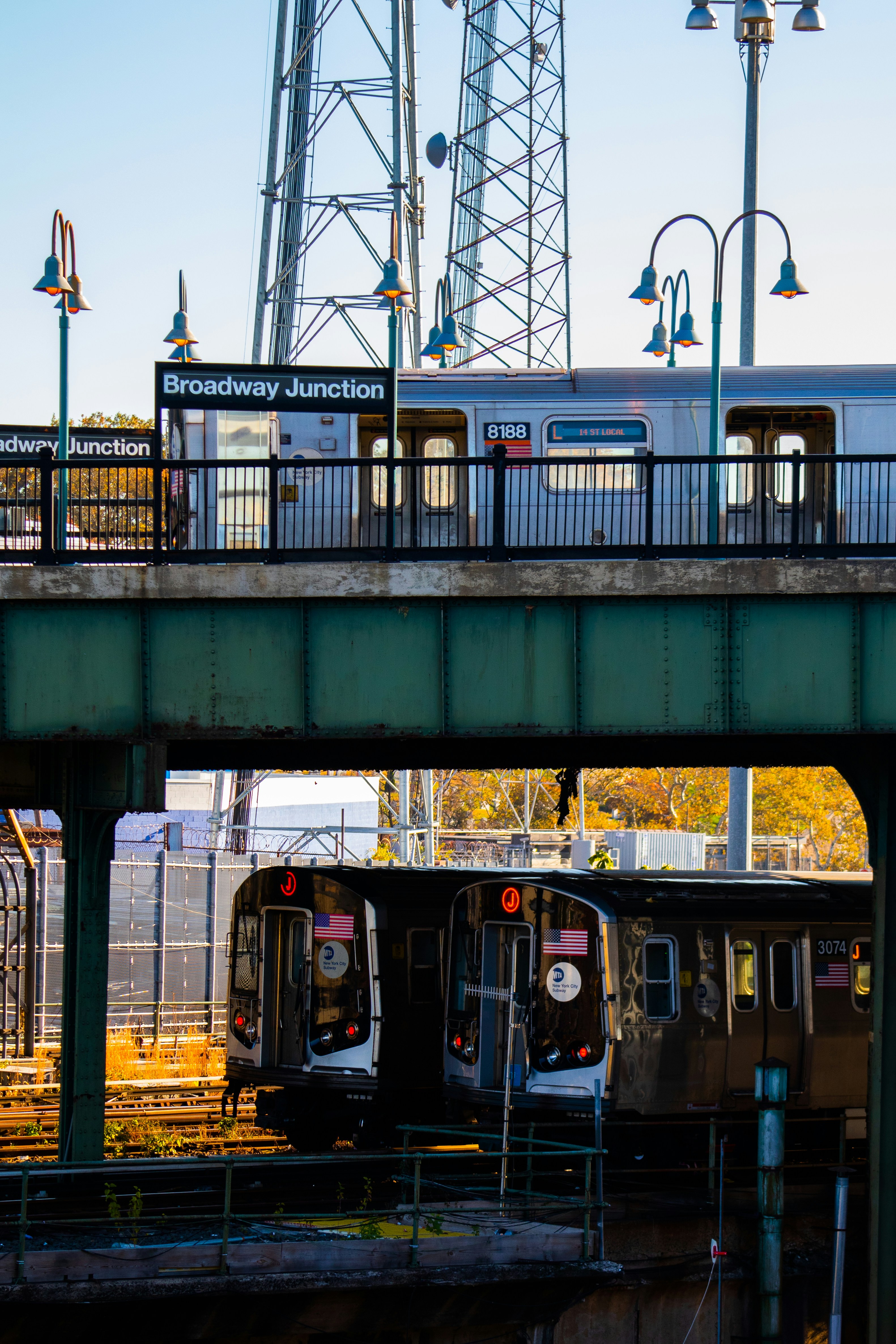 a train traveling over a bridge next to a train station