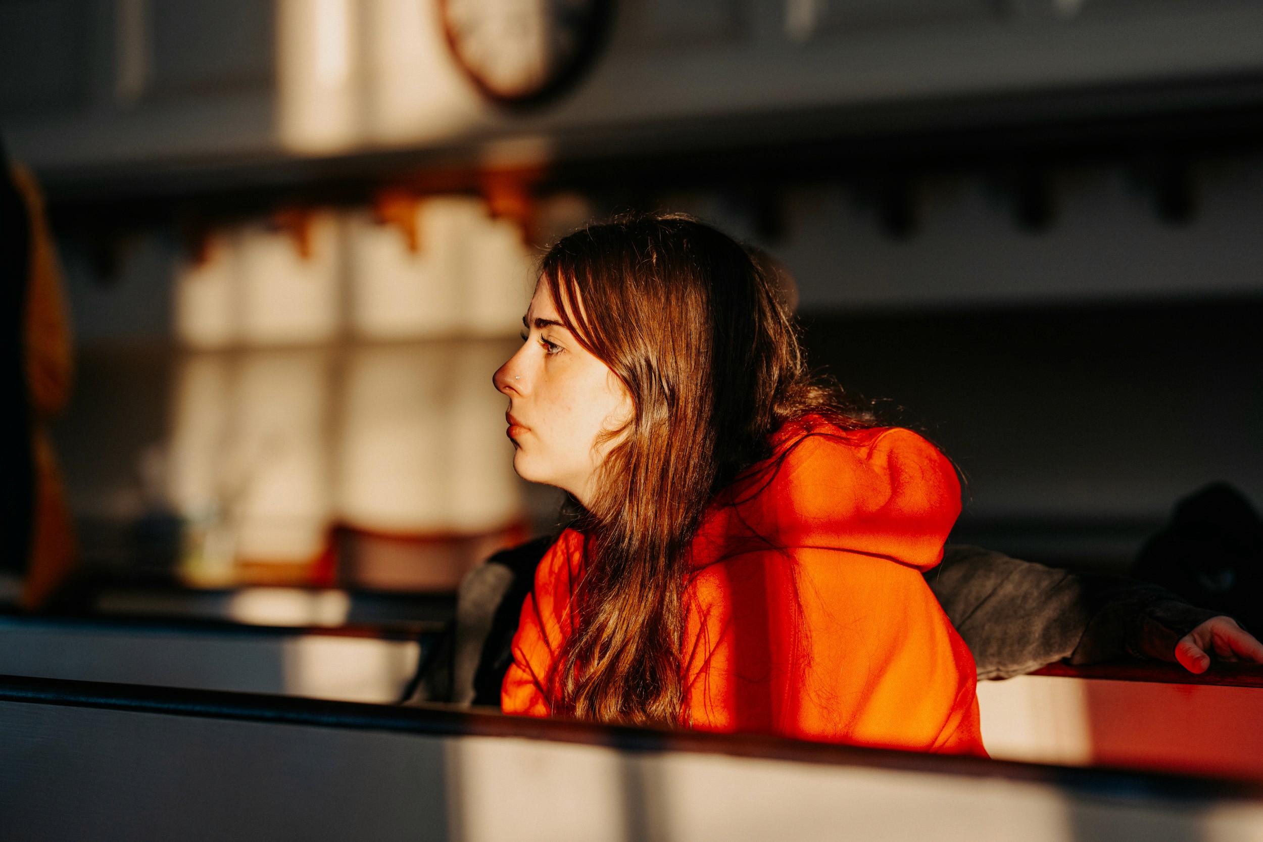 Audience member listening during a performance at the Queer Open Mic (QOM) hosted by be; community in Bridgewater, Massachusetts