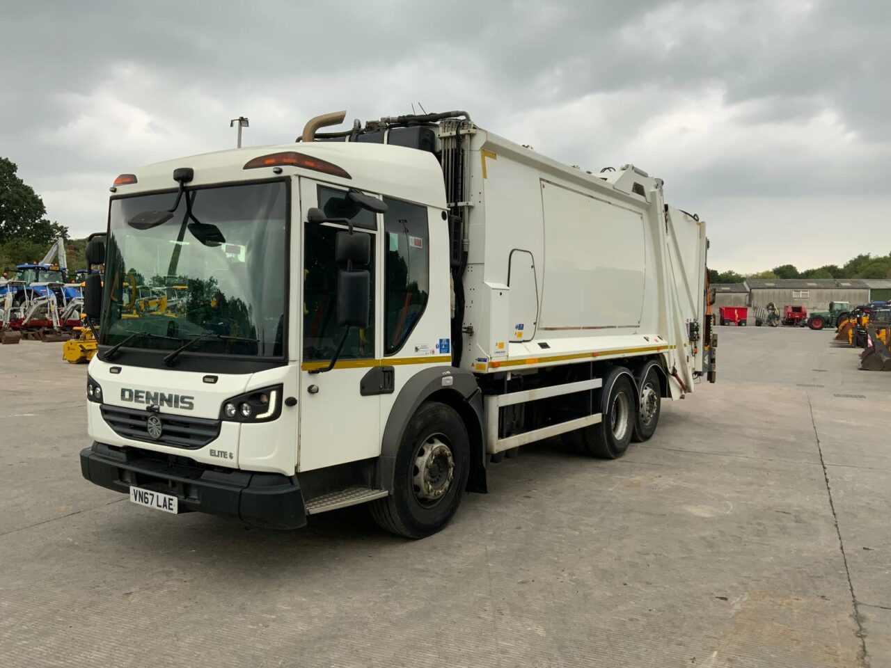 Close-up of a dark green leaf showing its textured surface and central vein against a muted background.