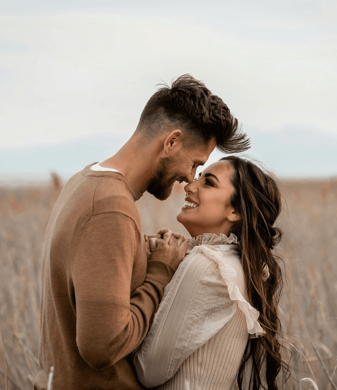 a woman stares into a man's eyes lovingly