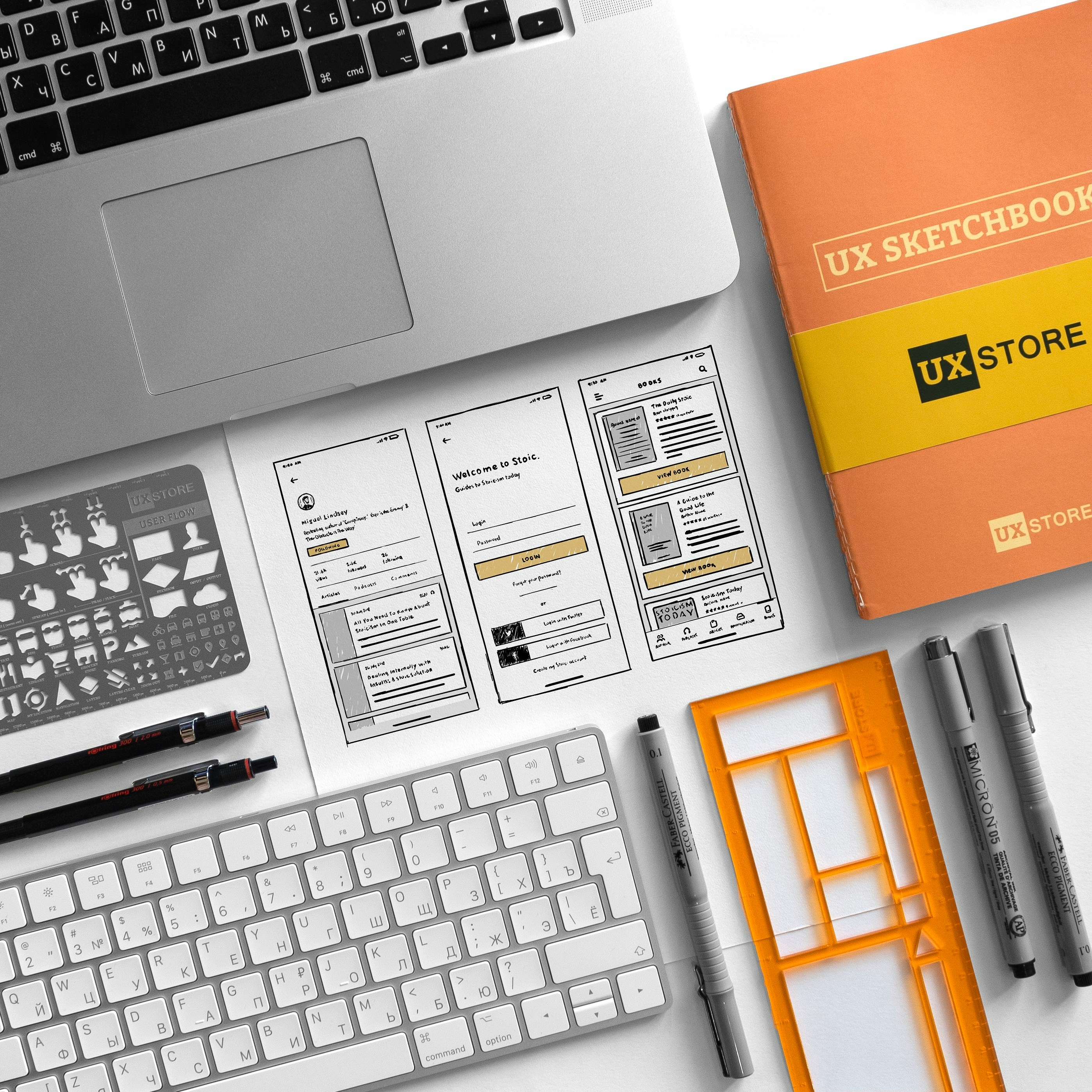 UX Sketchbook beside MacBook