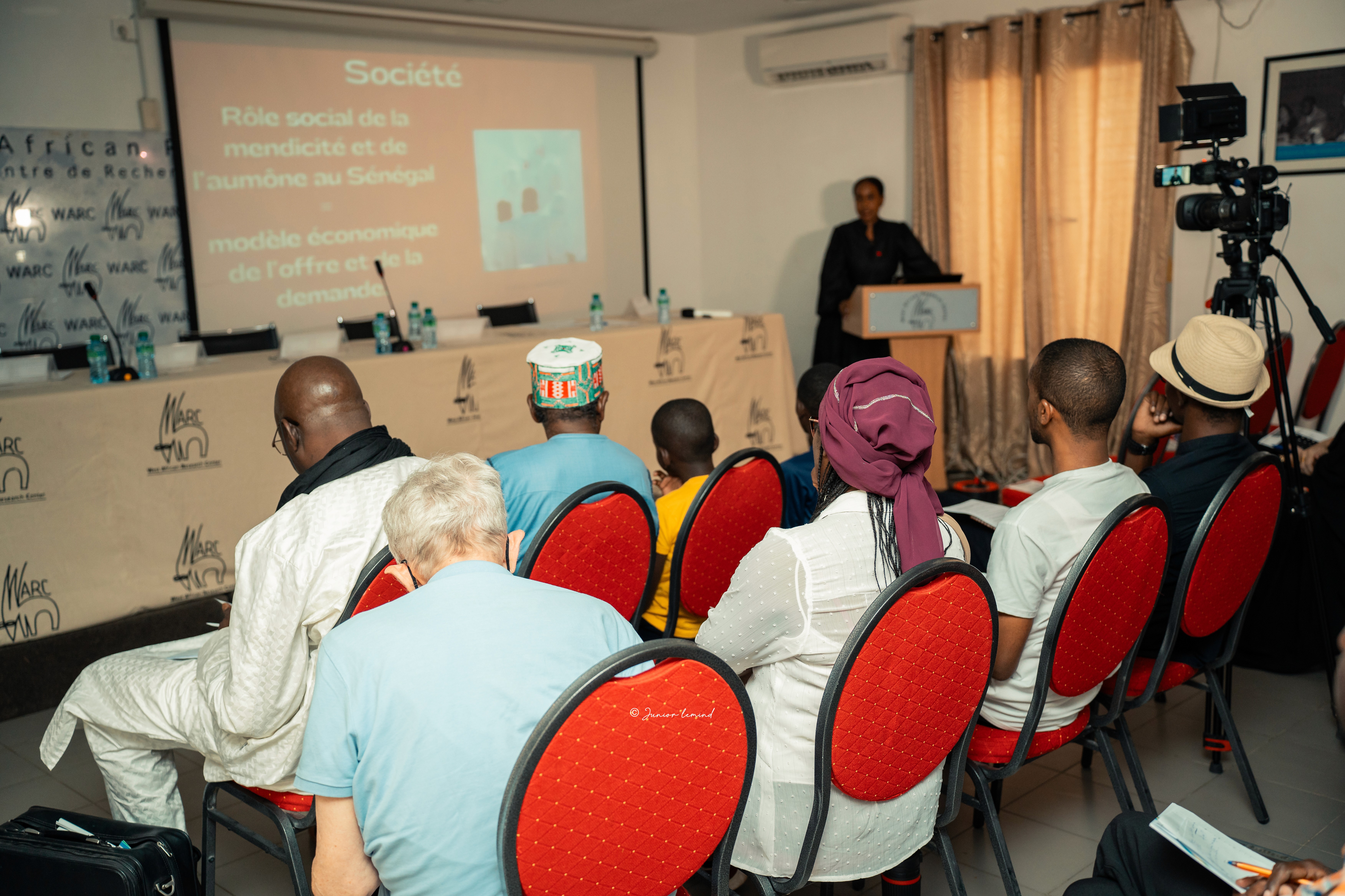 group of women in red and white dress standing on brown wooden bar during daytime