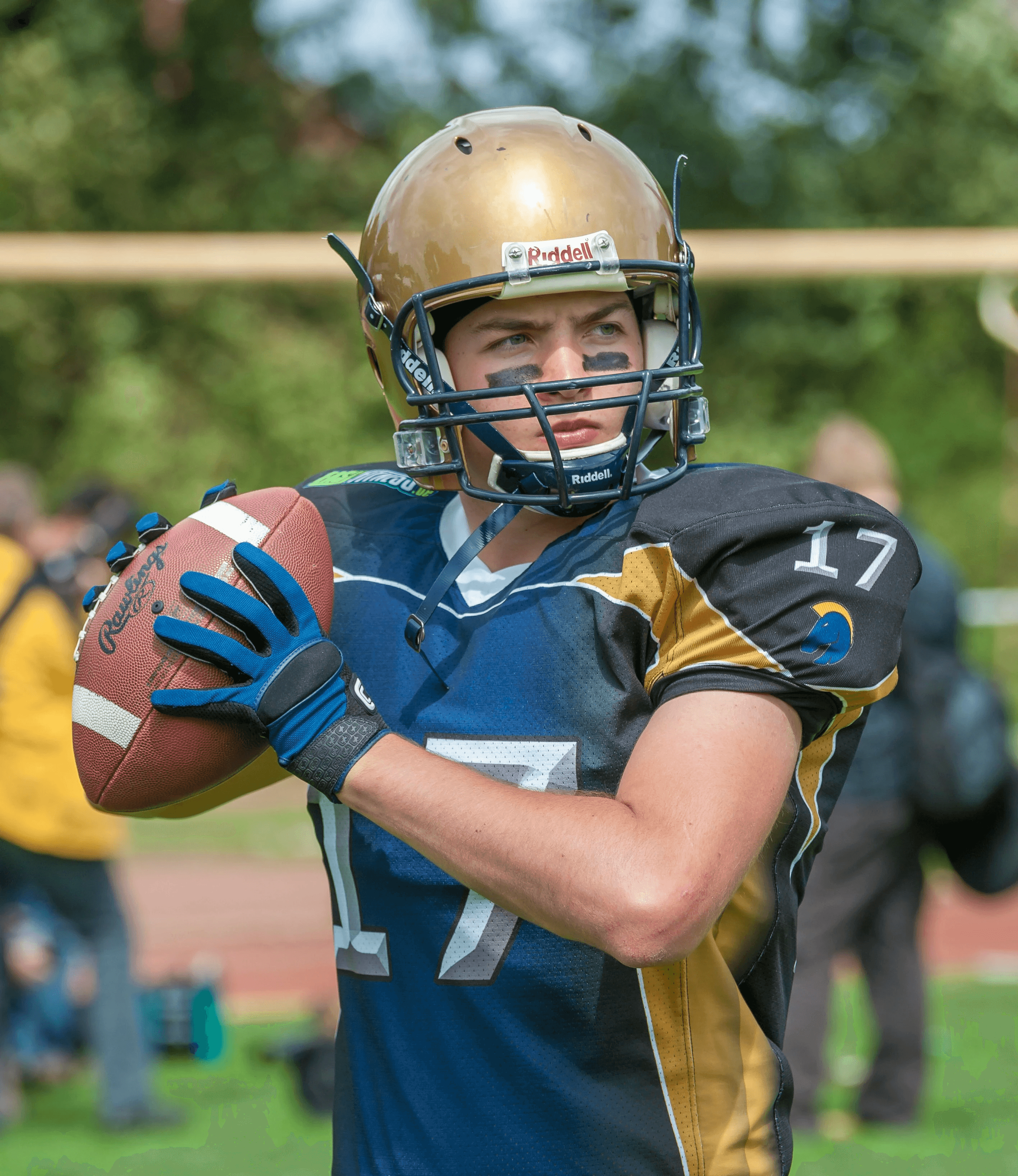 a football player holding a football on a field