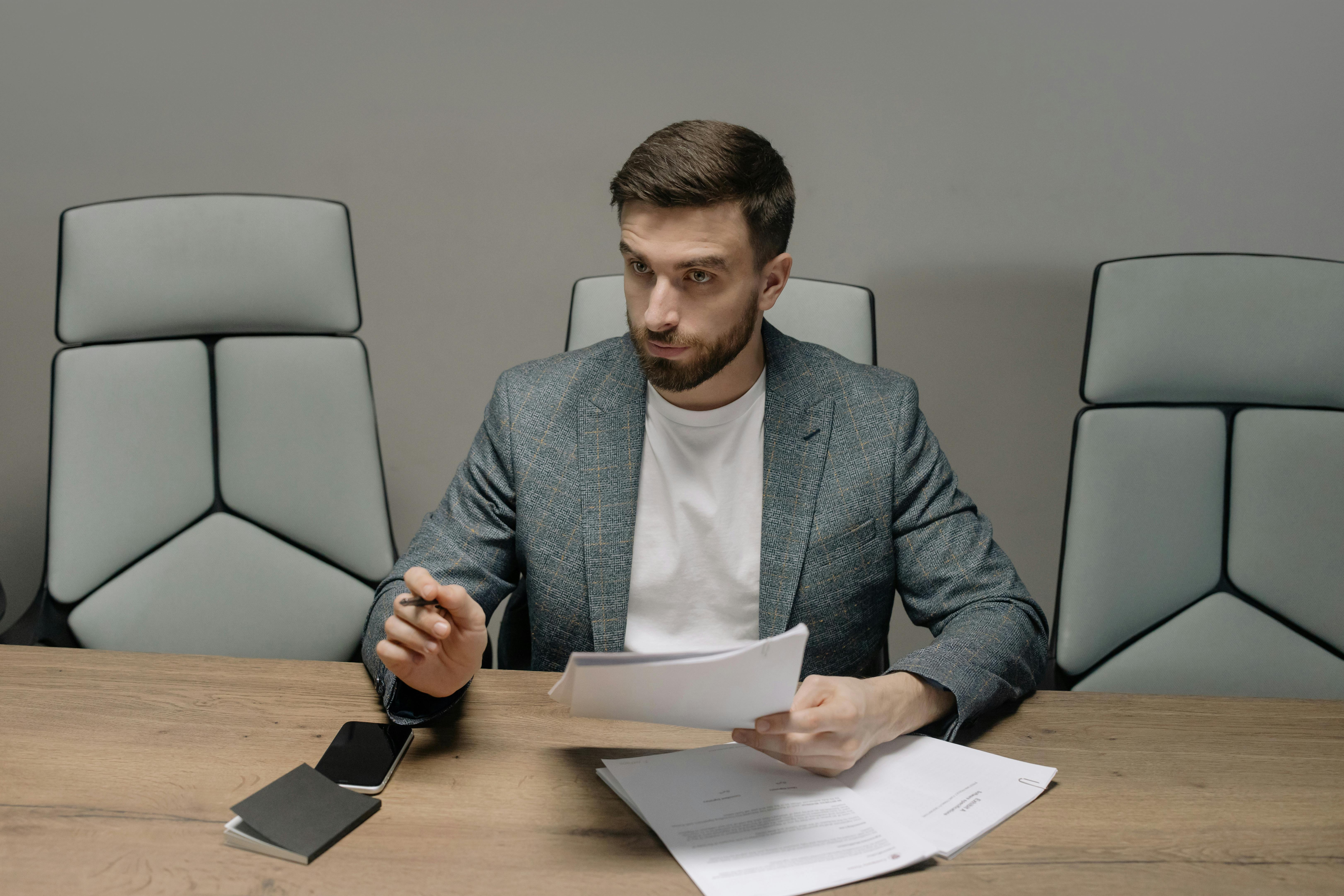 Broker wearing suit jacket holding papers