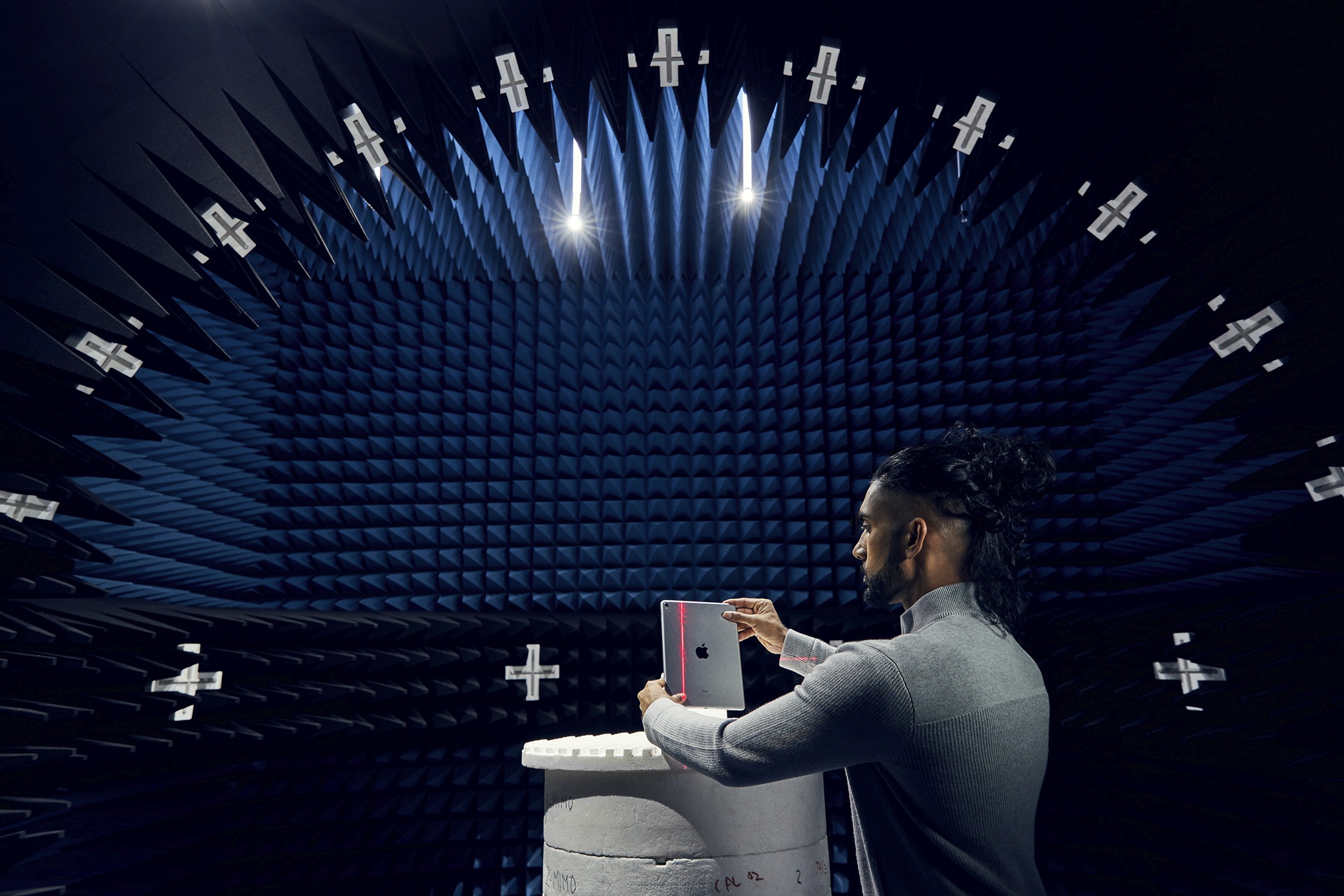 An Apple engineer testing an iPad in an anechoic chamber