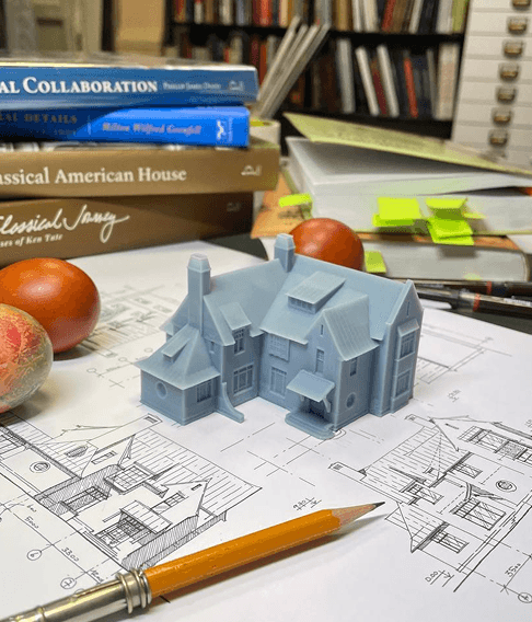 3d printed grey house on a architectural blueprint