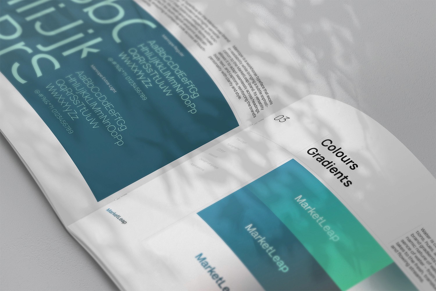 Open brand guideline booklet spread displaying the ‘03 Colours Gradients’ section. The left page showcases typography samples in various font weights, set against a teal background. The right page highlights gradient swatches in teal and green-blue tones, branded as ‘MarketLeap’. Soft shadows of leaves are cast across the spread, enhancing the aesthetic.