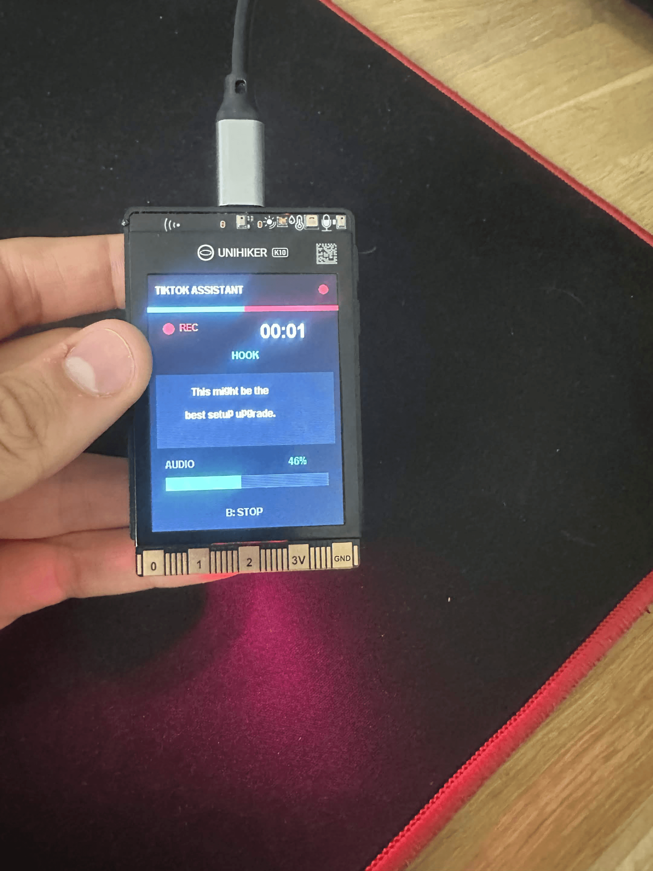 UNIHIKER K10 TikTok filming assistant displaying shot instructions beside a smartphone.