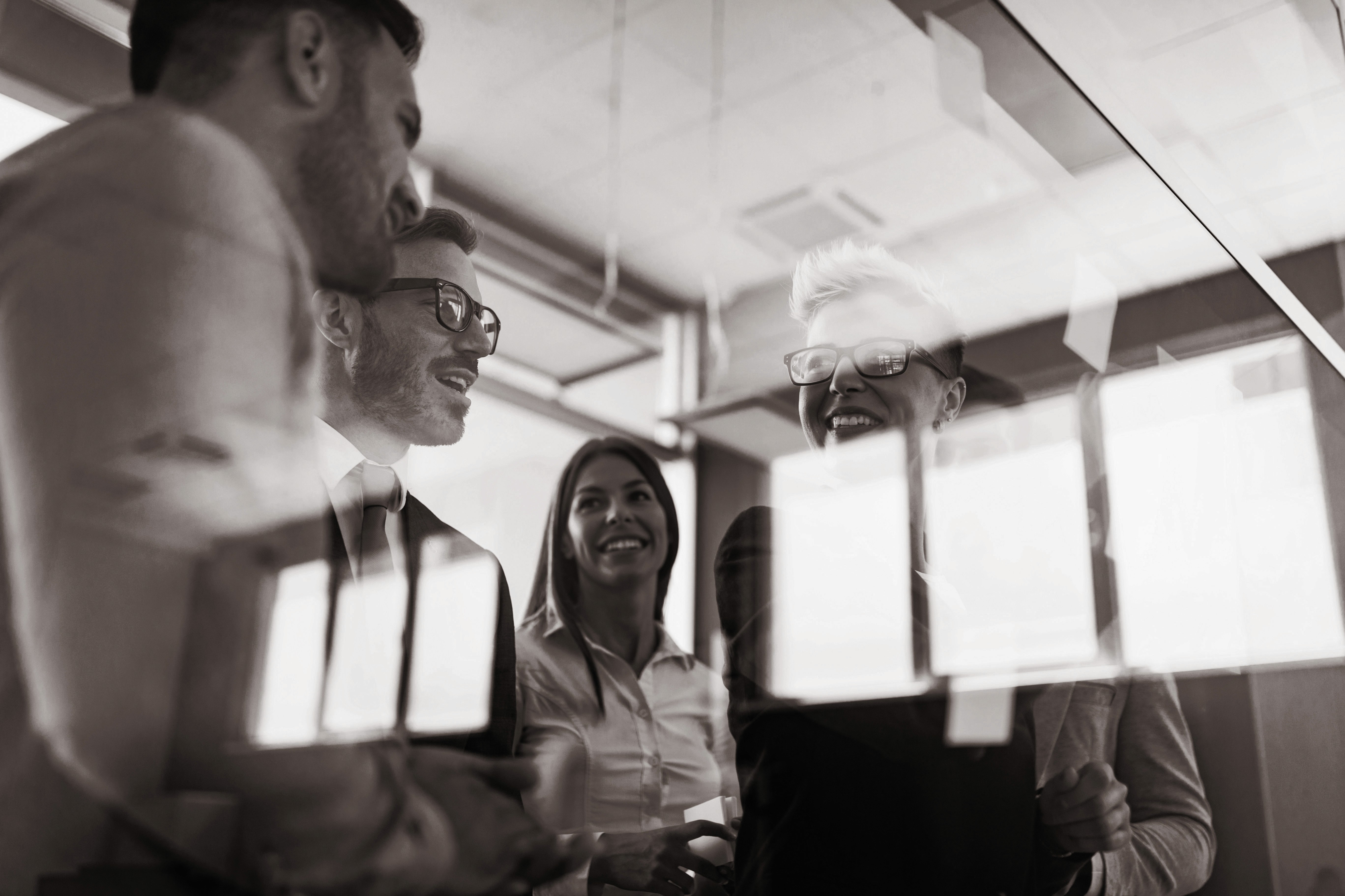 Young business people having fun and chatting at workplace office