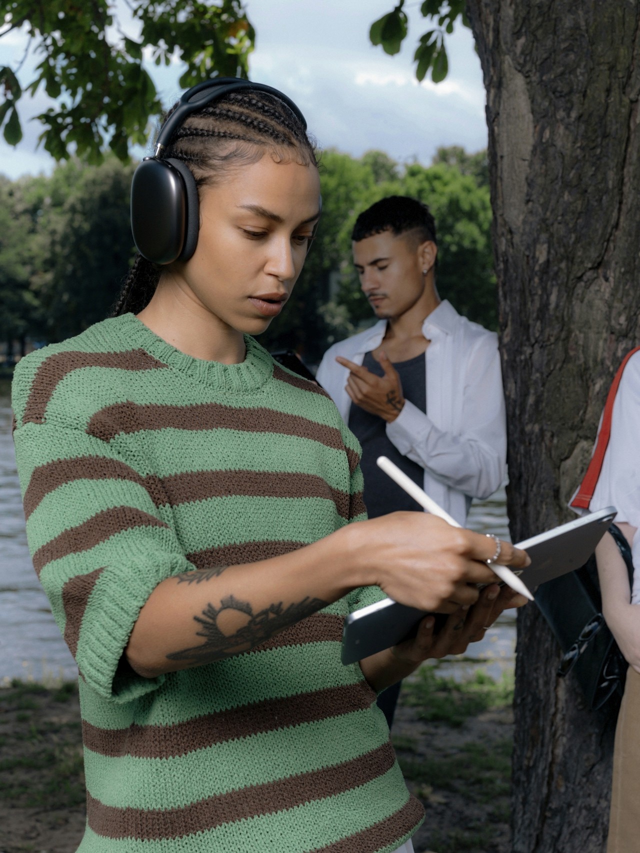 Girl wearing headphones noting something on notebook