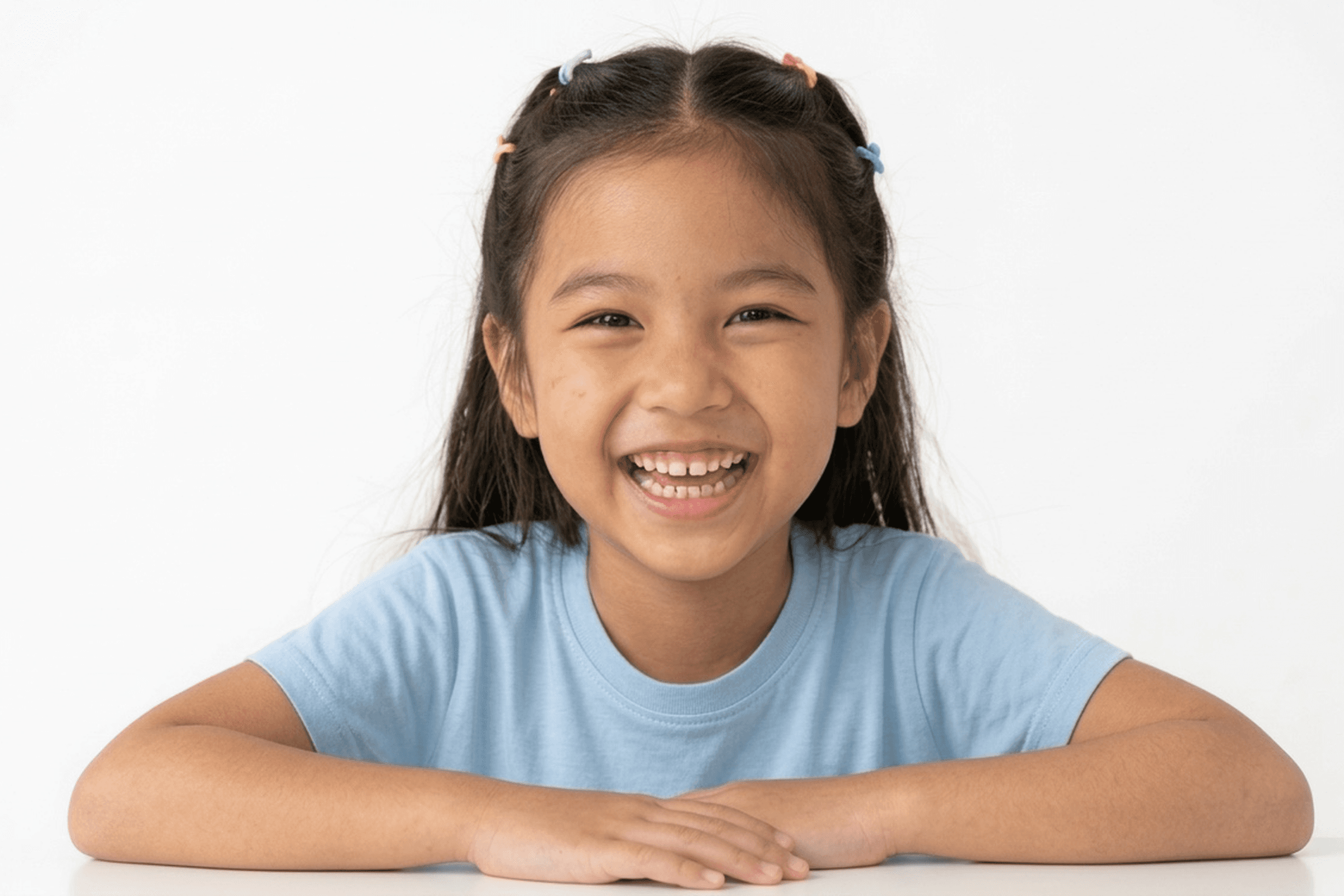 A young girl with a sweet, gentle smile, representing specialized pediatric dentistry for kids of all ages in Bolton.