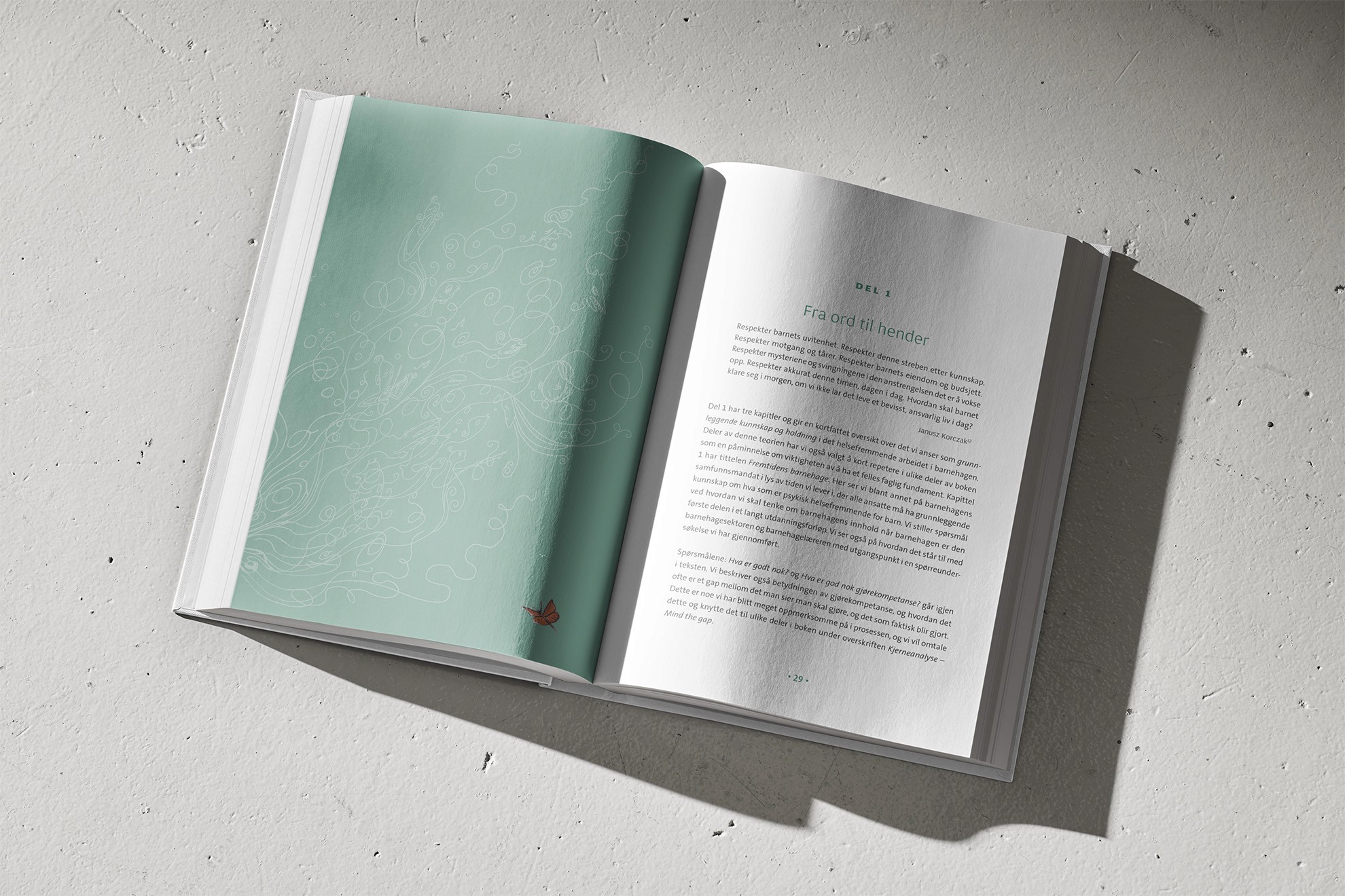 Otwarta książka z rozdziałem „Fra ord til hender”, leżąca na fakturowanej powierzchni.