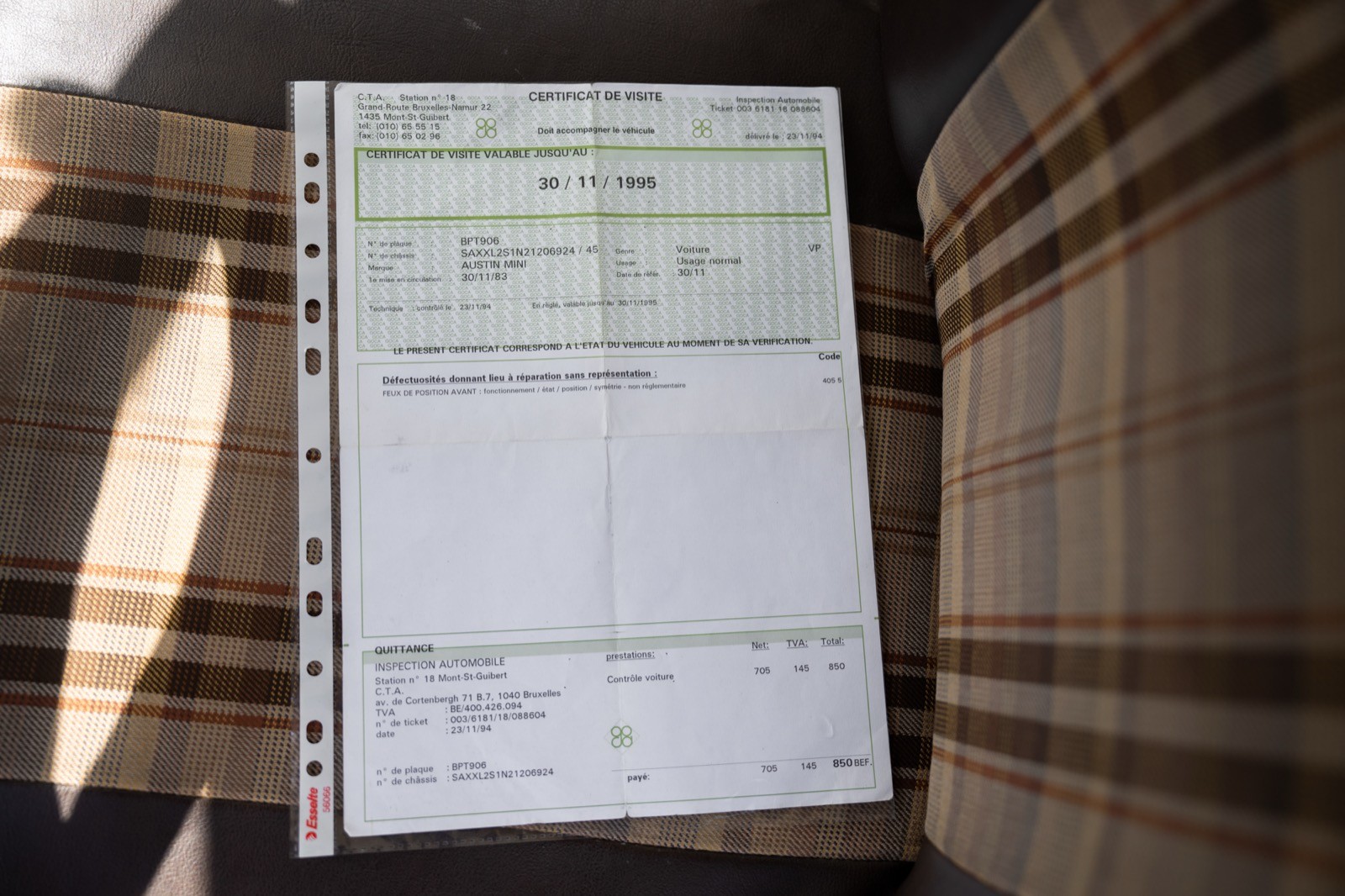 A close-up of a notebook page with handwritten entries, lying on a wooden surface.