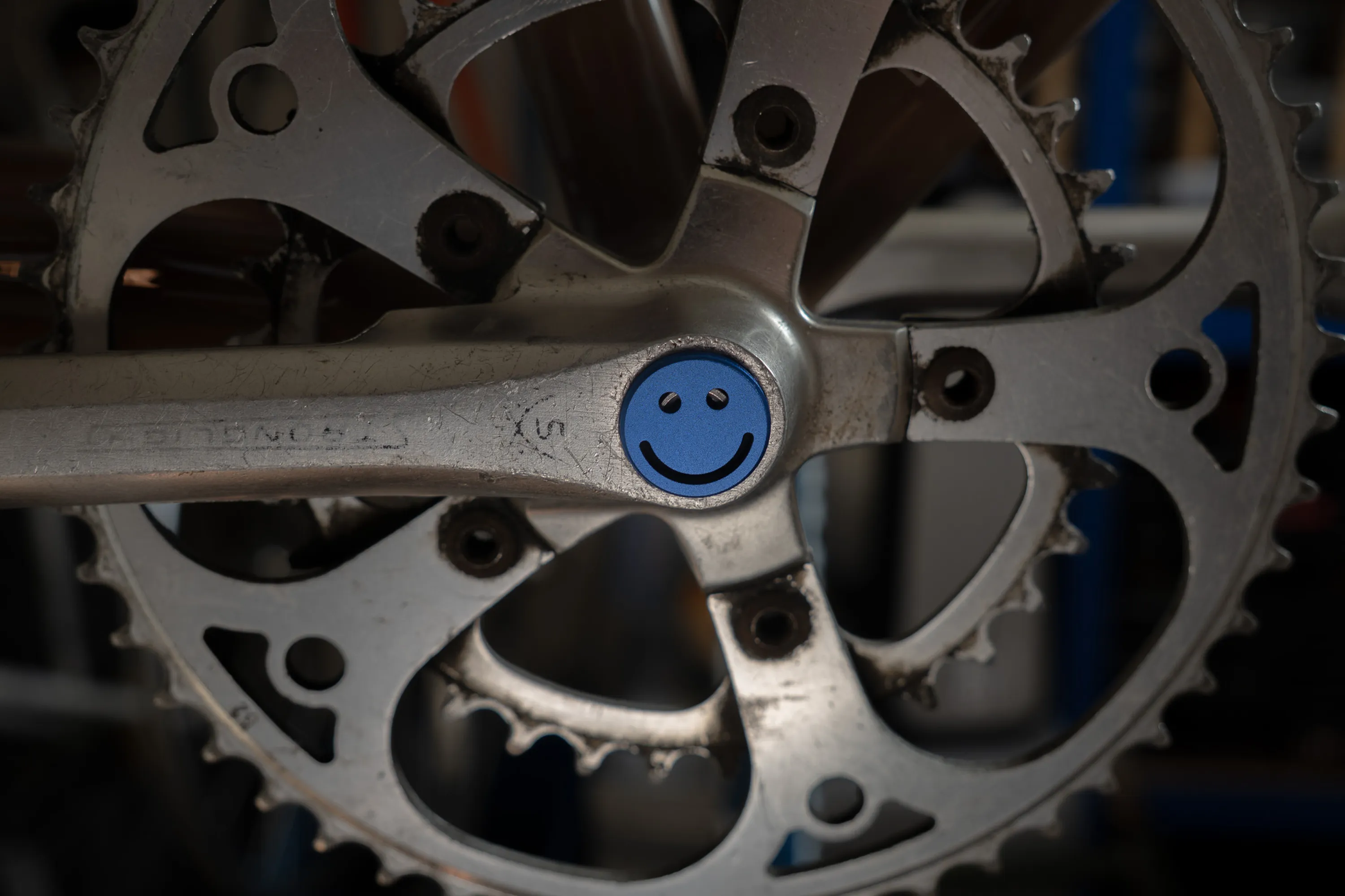 A close up of a person working on a bike crankset
