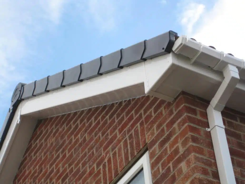 two men working on the roof of a house
