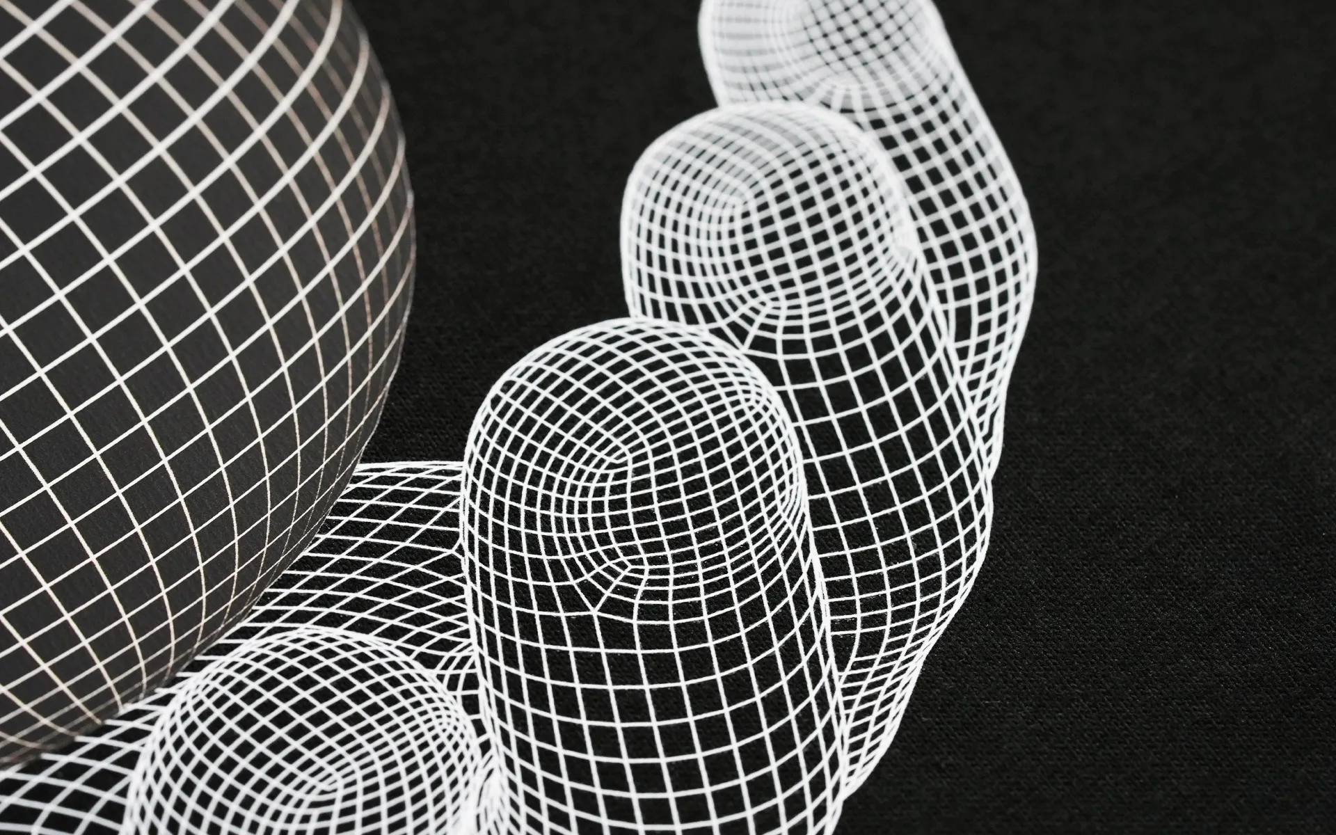Detailed view of intricate white grid lines and wireframe sphere patterns on dark fabric, demonstrating the high-precision printing capabilities of the Gravity Pro DTF printer.