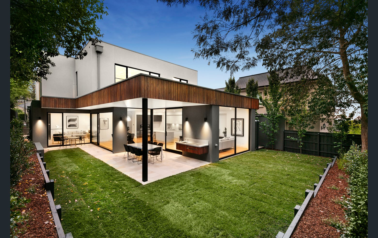 Luxurious modern interior with a sculptural art piece, floating books, a sleek marble bench, ambient lighting, and a gold metal partition