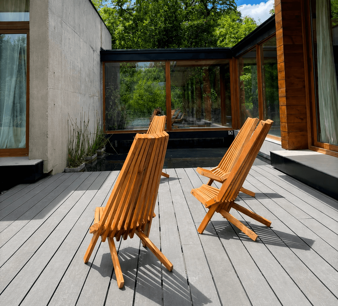 bench and dining table near body of water under calm sky