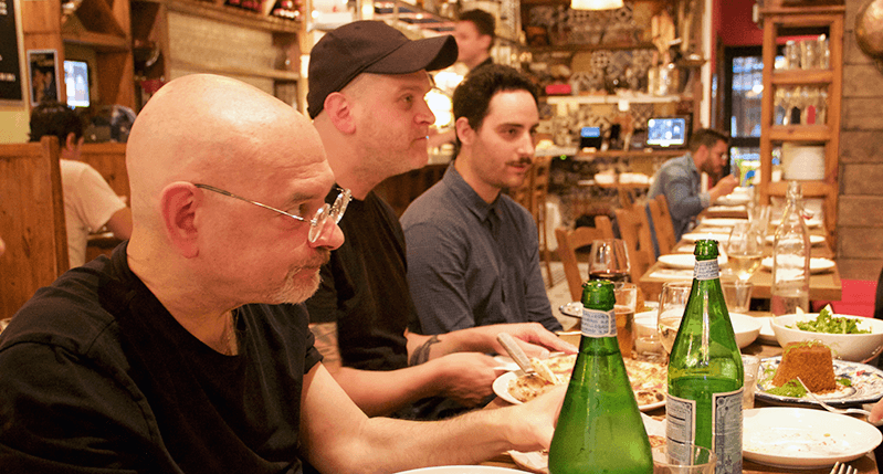 A photo showing people chatting at a restaurant table.