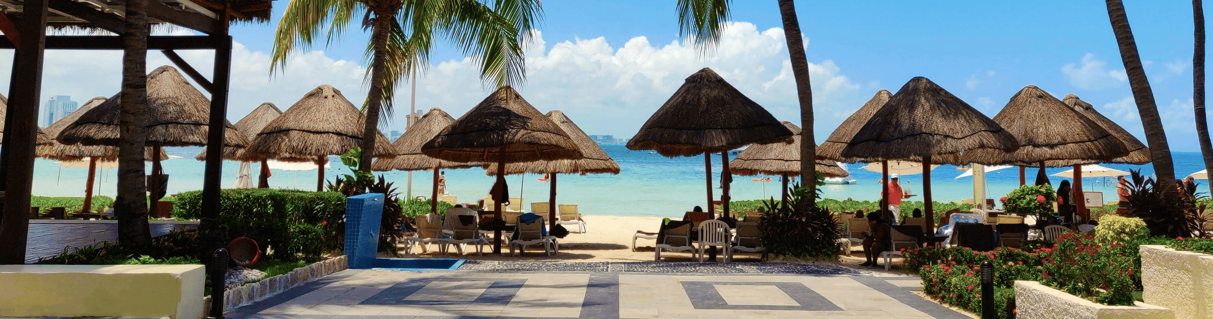 a beach with umbrellas and chairs