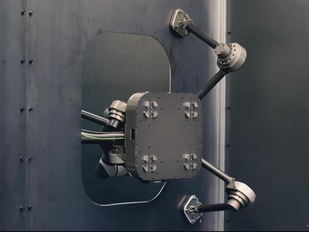 A magnetic-foot quadruped holding its posture on a steel structure