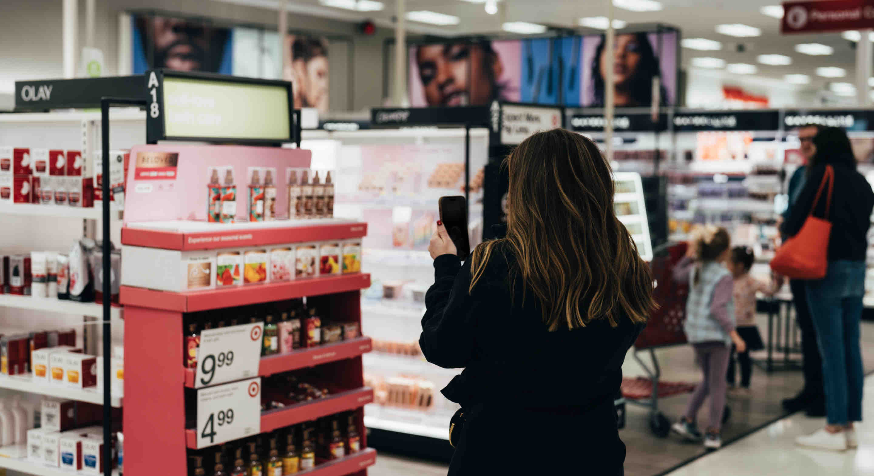 Woman in a retail store using her phone.