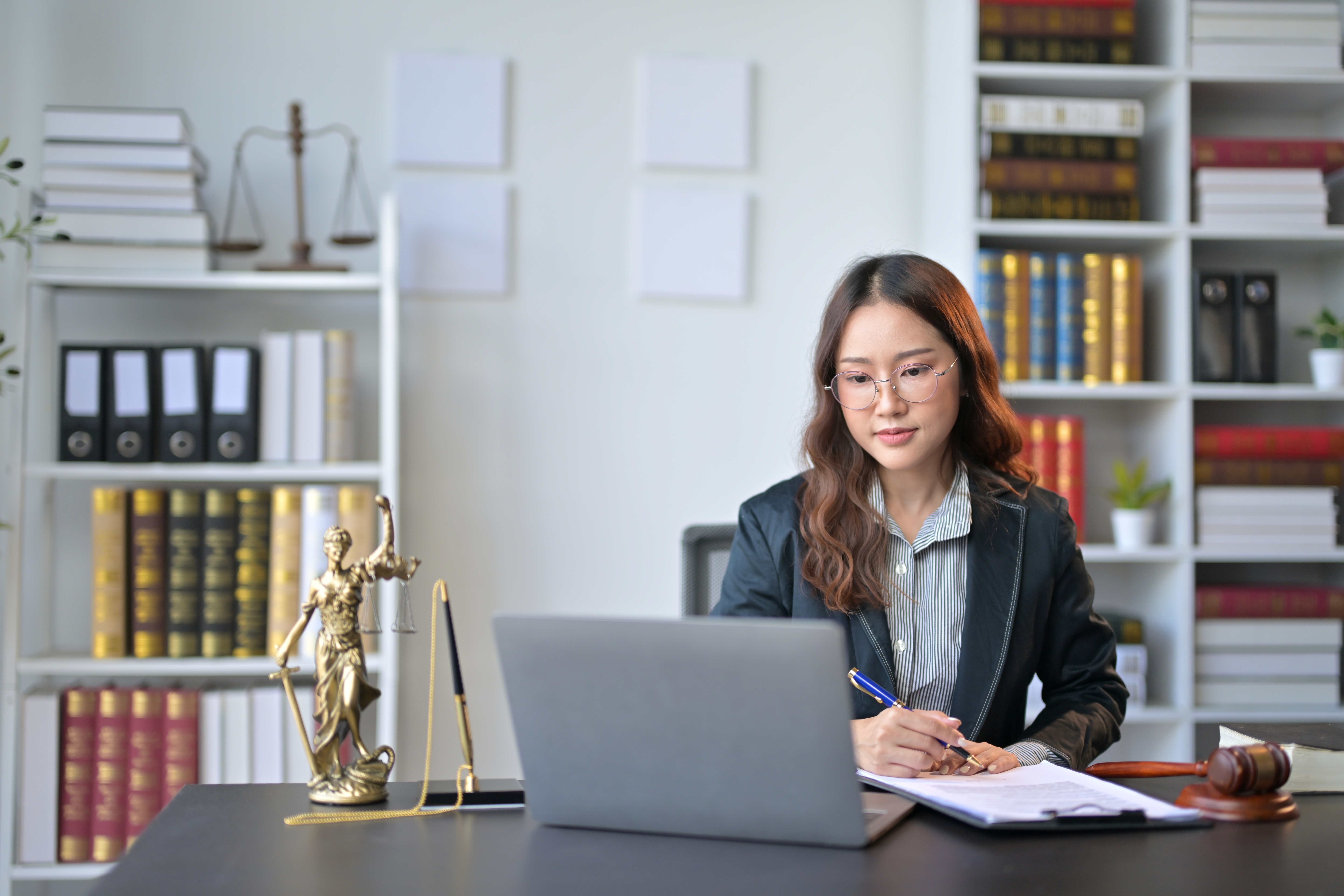 Image of a professional lawyer working on legal documents in a modern office.