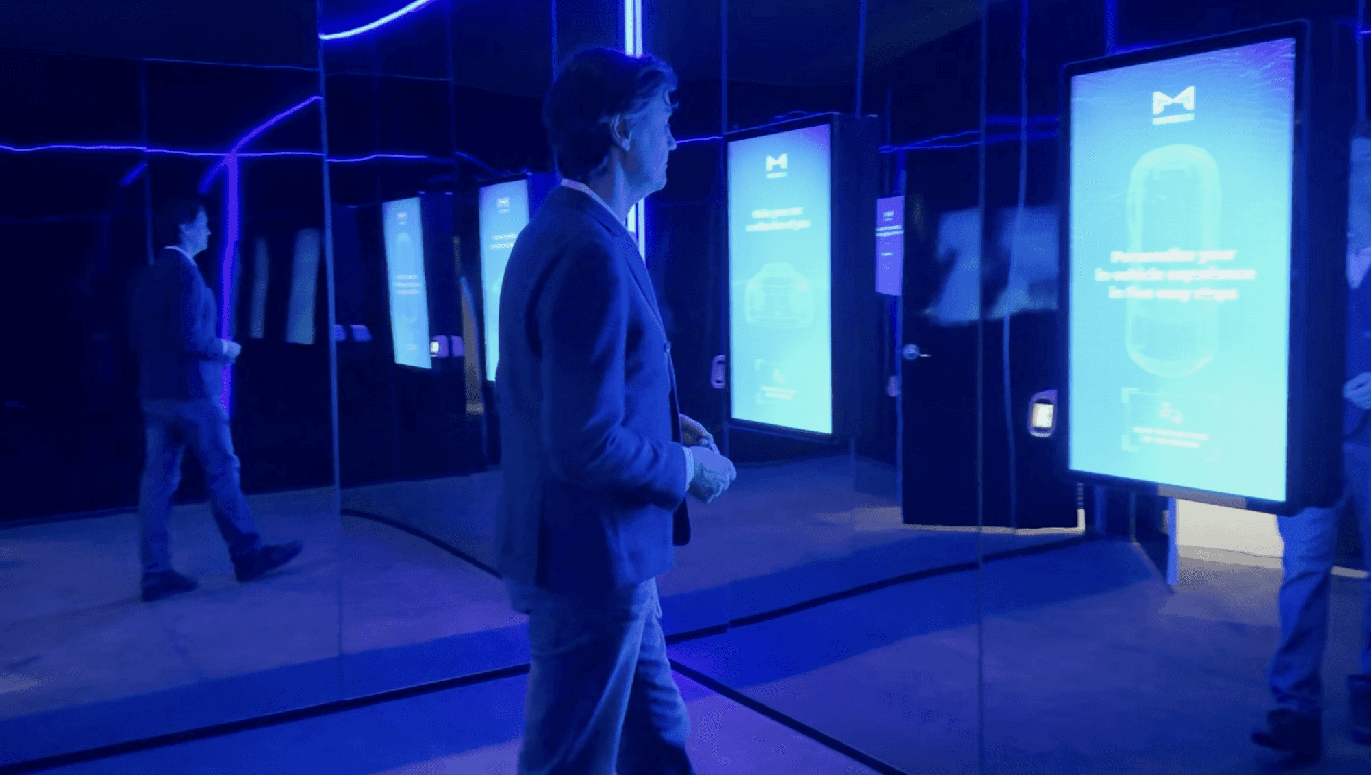 Una persona cammina nell'esposizione immersiva realizzata per Marelli