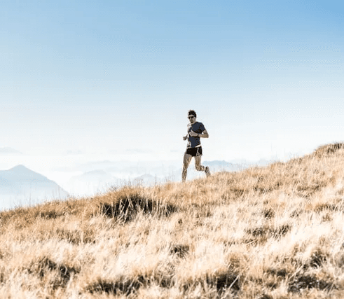 Runner on a dry hillside trail