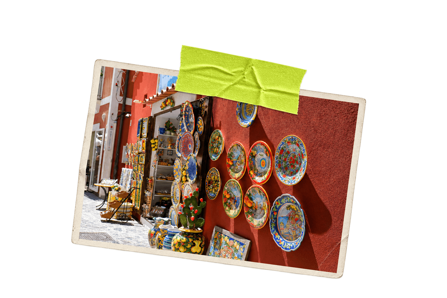 Printed photograph of painted ceramic plates displayed on a red storefront wall.
