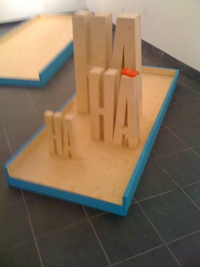 ha ha ha words made of wood on a small wooden tray