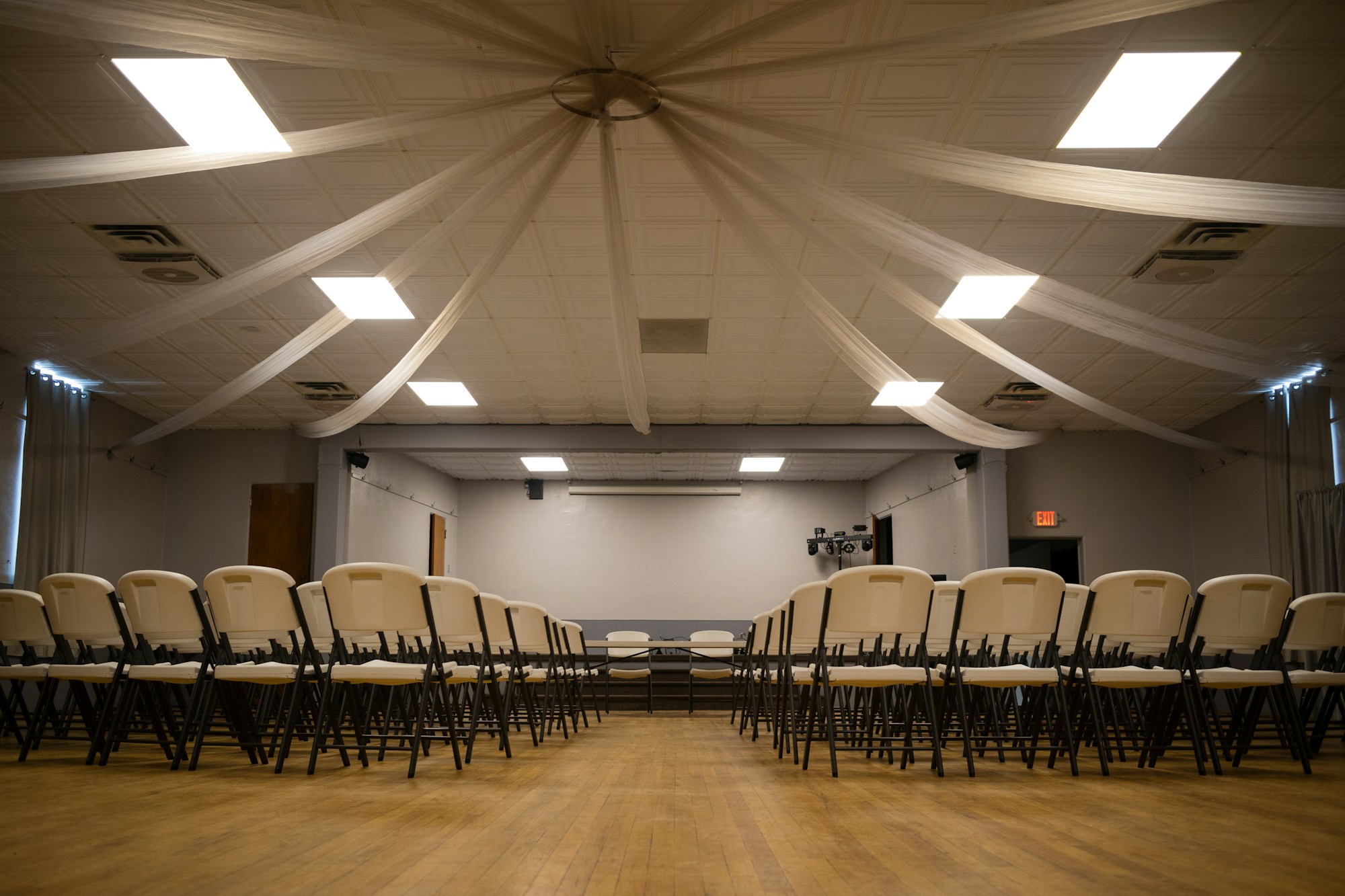 Theatre-style seating facing the stage, The Hall at Neue Events