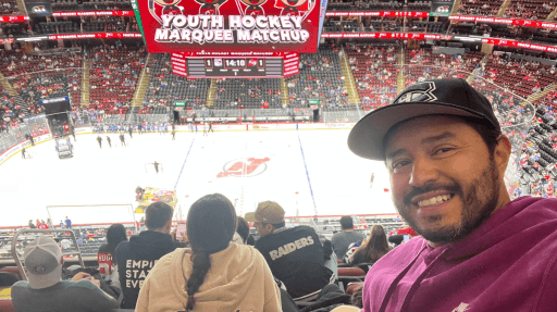 Image of Felipe Caro, illustrator from Inky Thinking watching an ice hockey match in New York