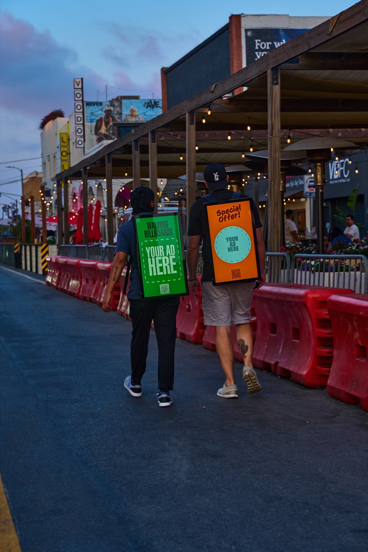 Wunderparks carriers moving through a nightlife district at dusk