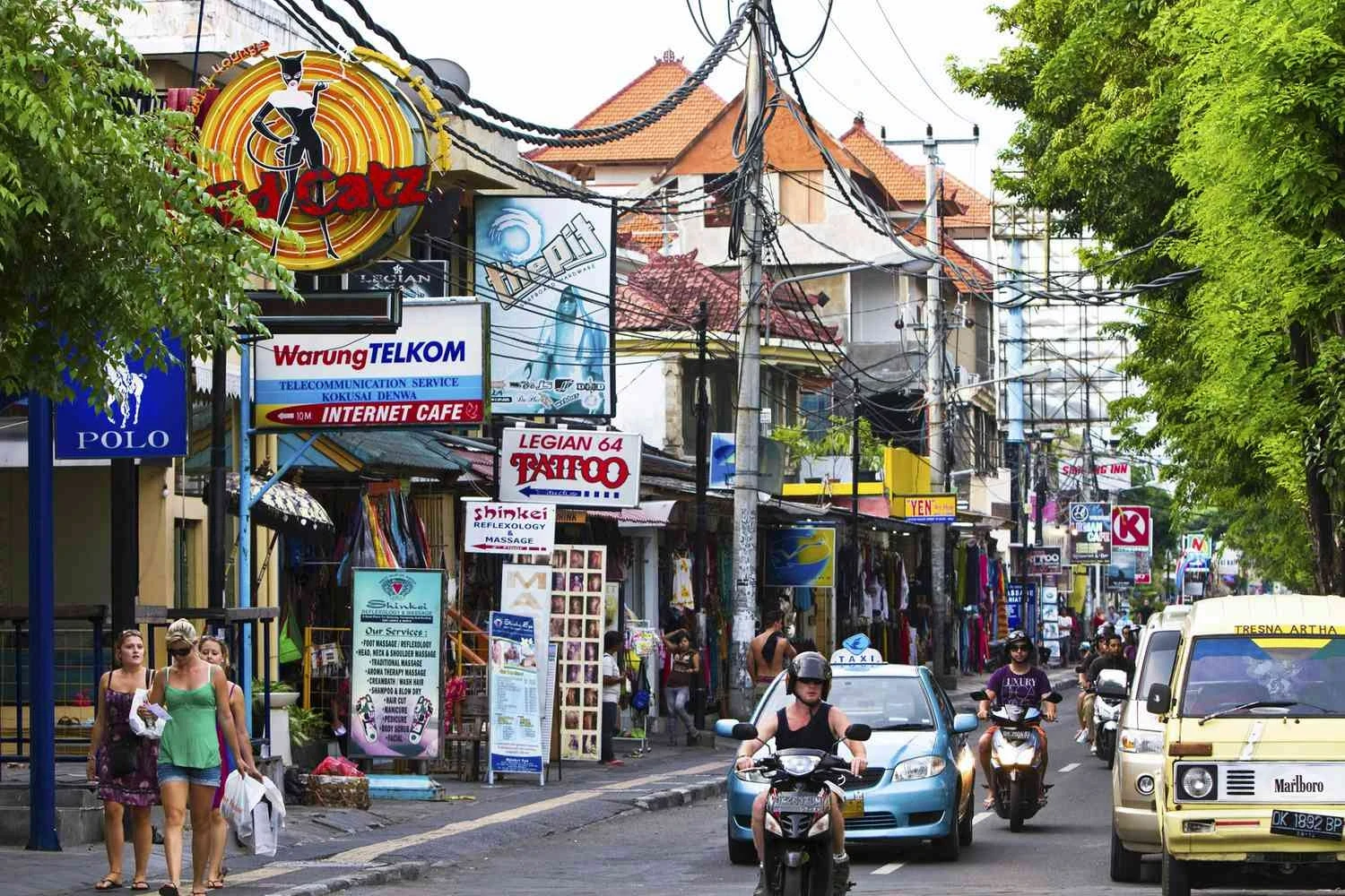 Bustling tropical city street daytime.