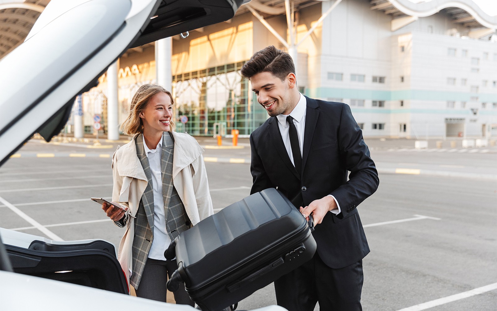 Private transfer service at London Stansted Airport with driver loading luggage.