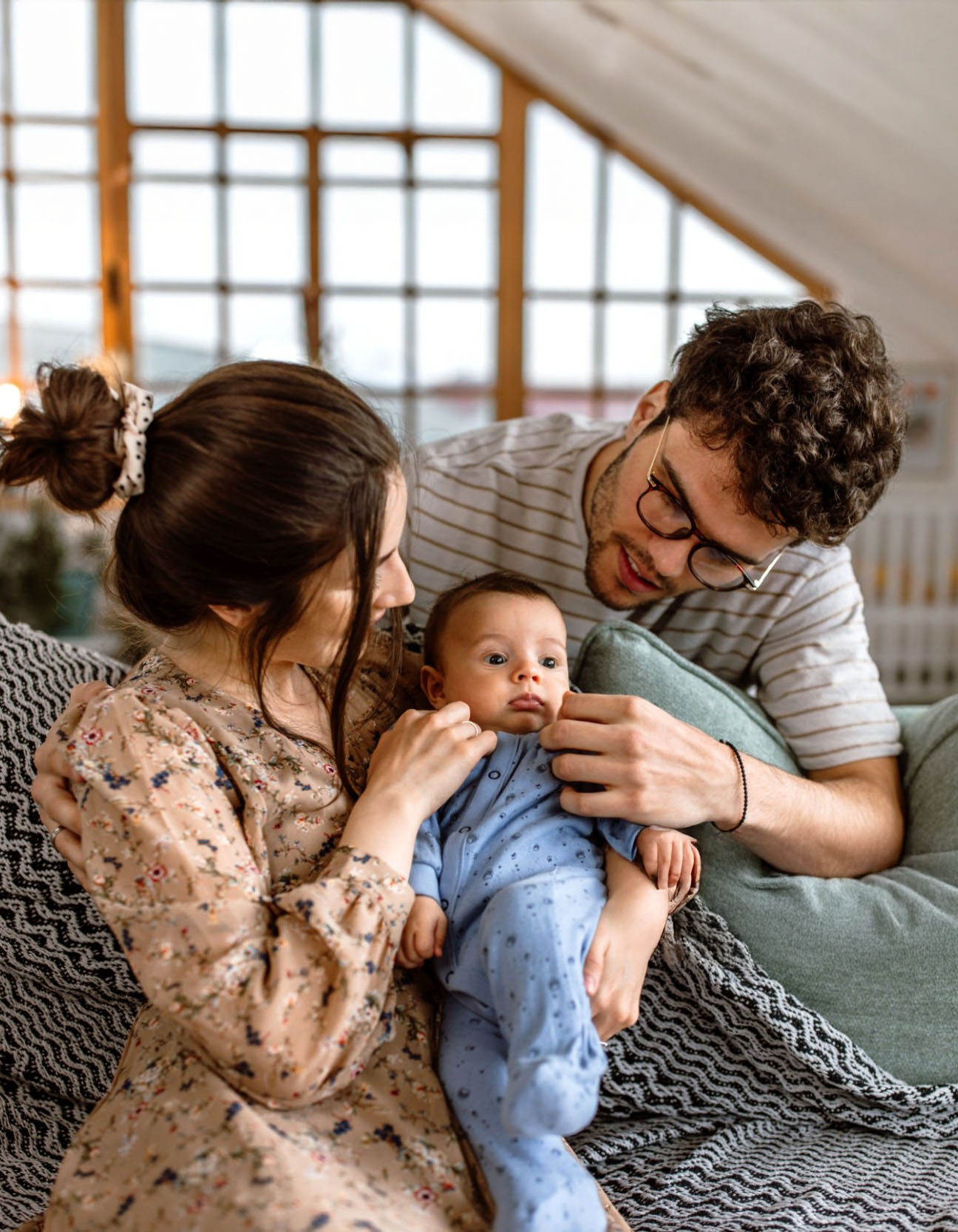 husband and wife with newborn baby