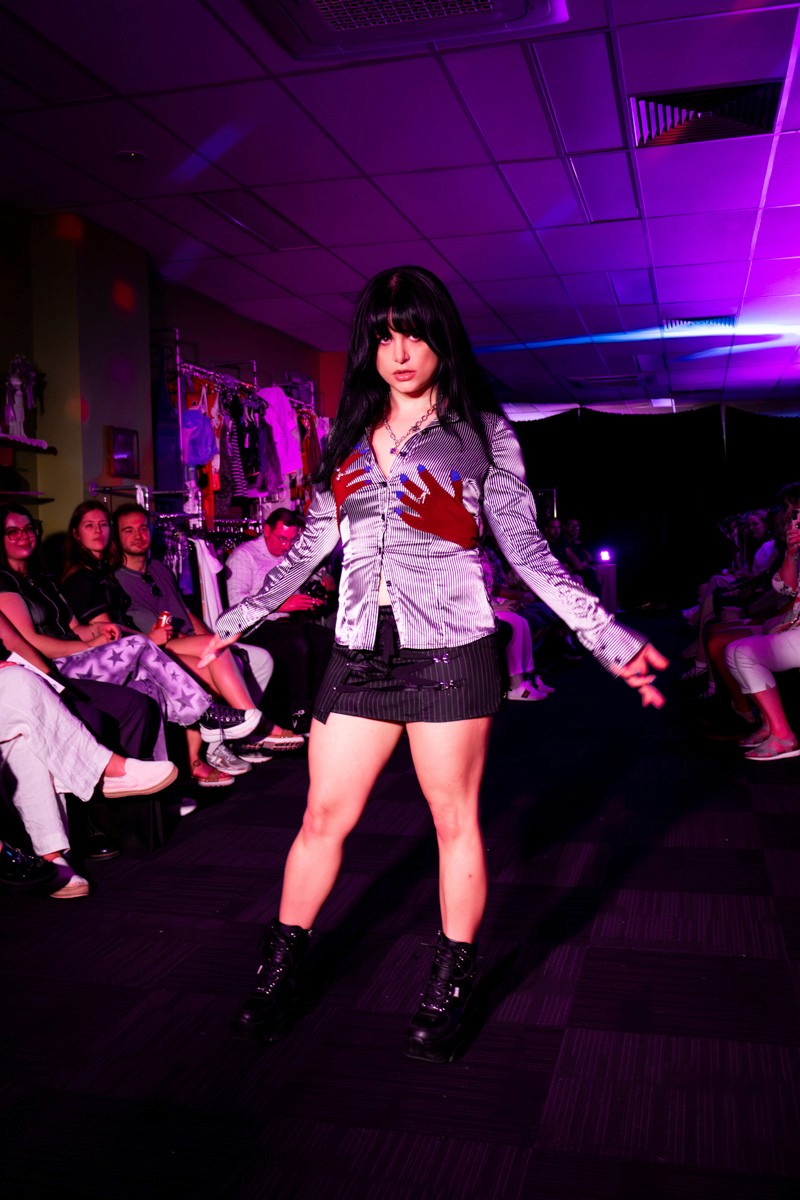 female model on runway wearing shirt with hand prints