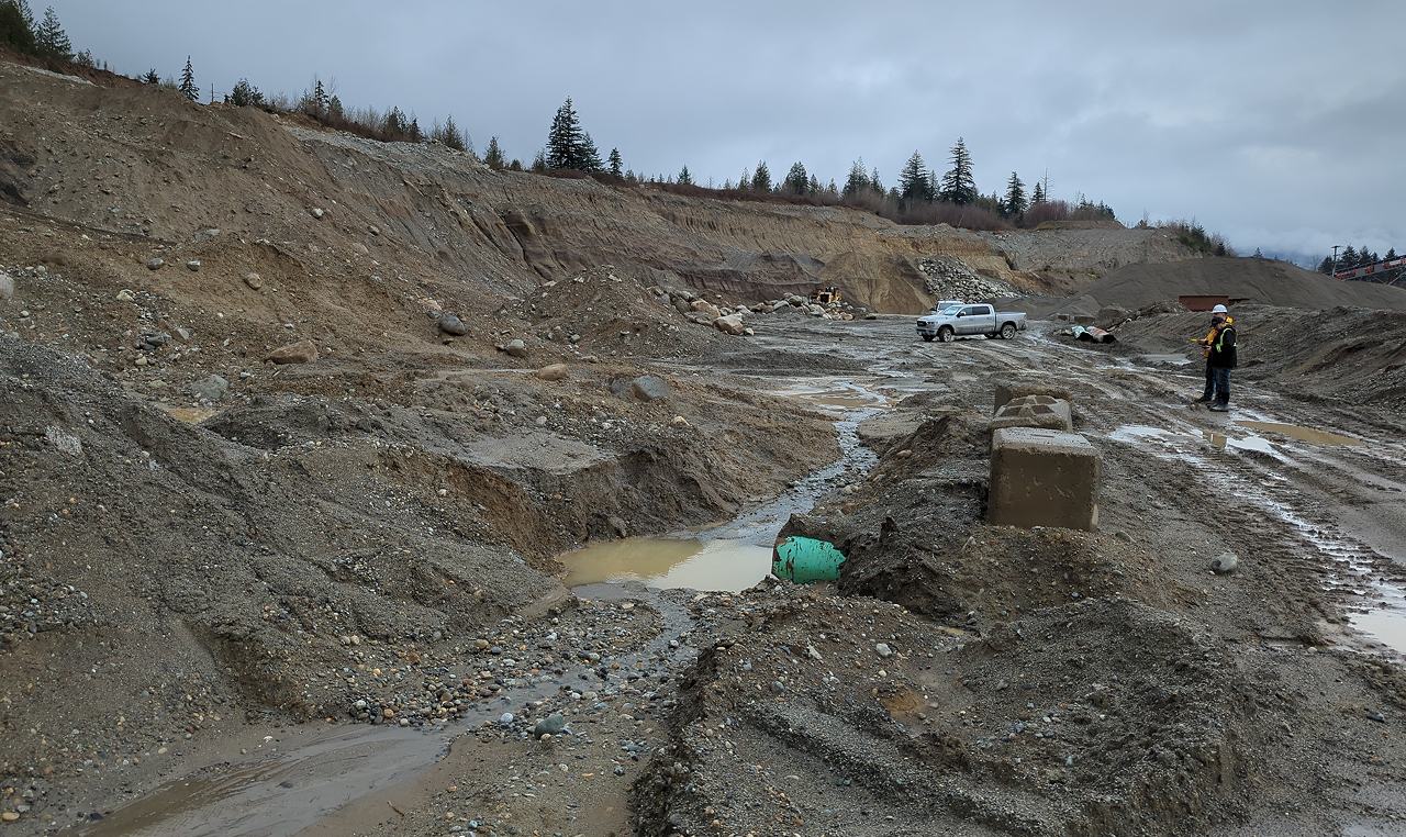 Engineer inspecting drainage features during site assessment at Woodbrook Aggregates gravel pit