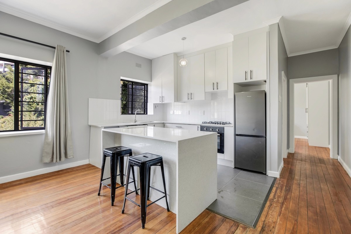 Modern fully furnished apartment kitchen with appliances included in Cape Town rental.