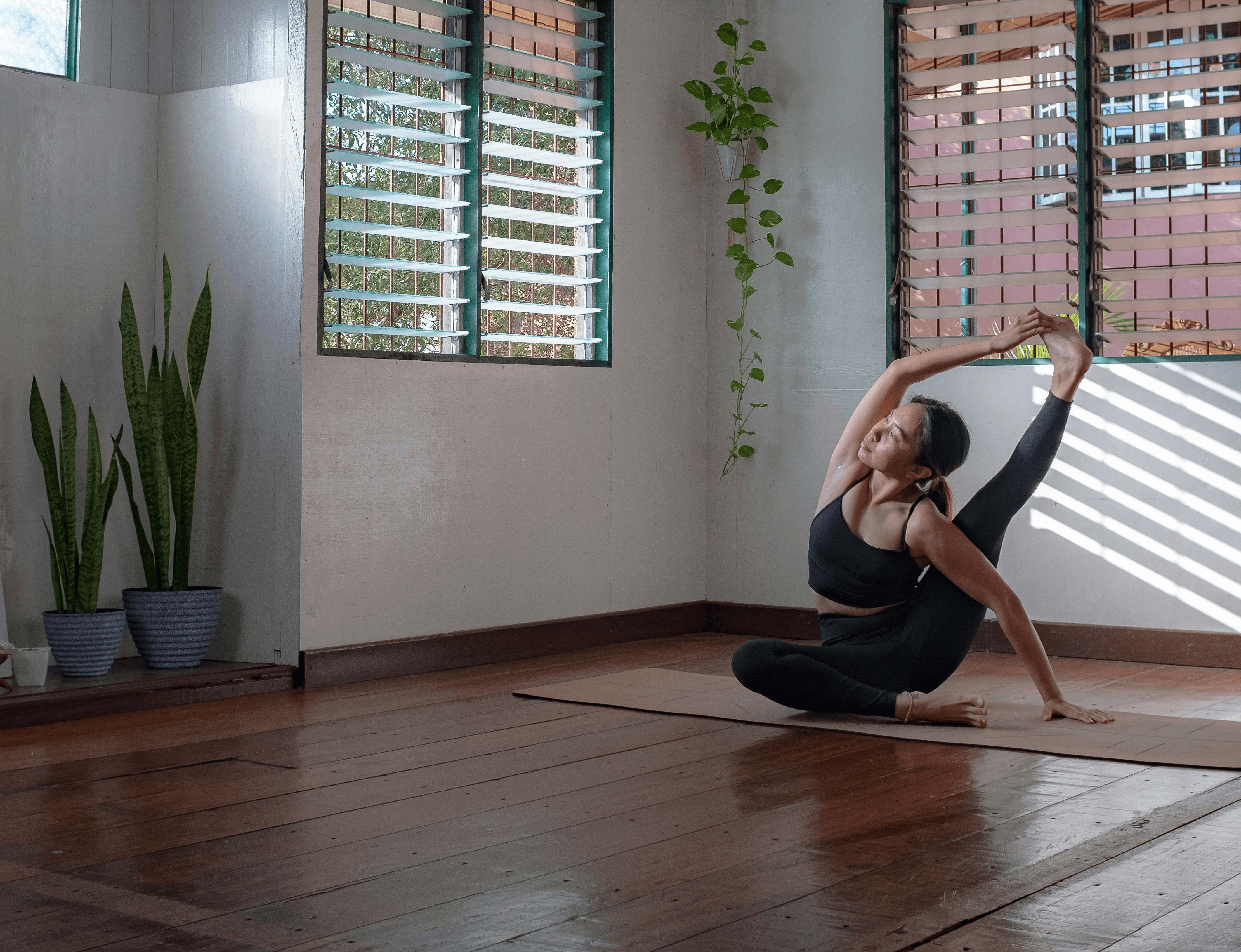 woman in black shirt and white pants sitting on chair