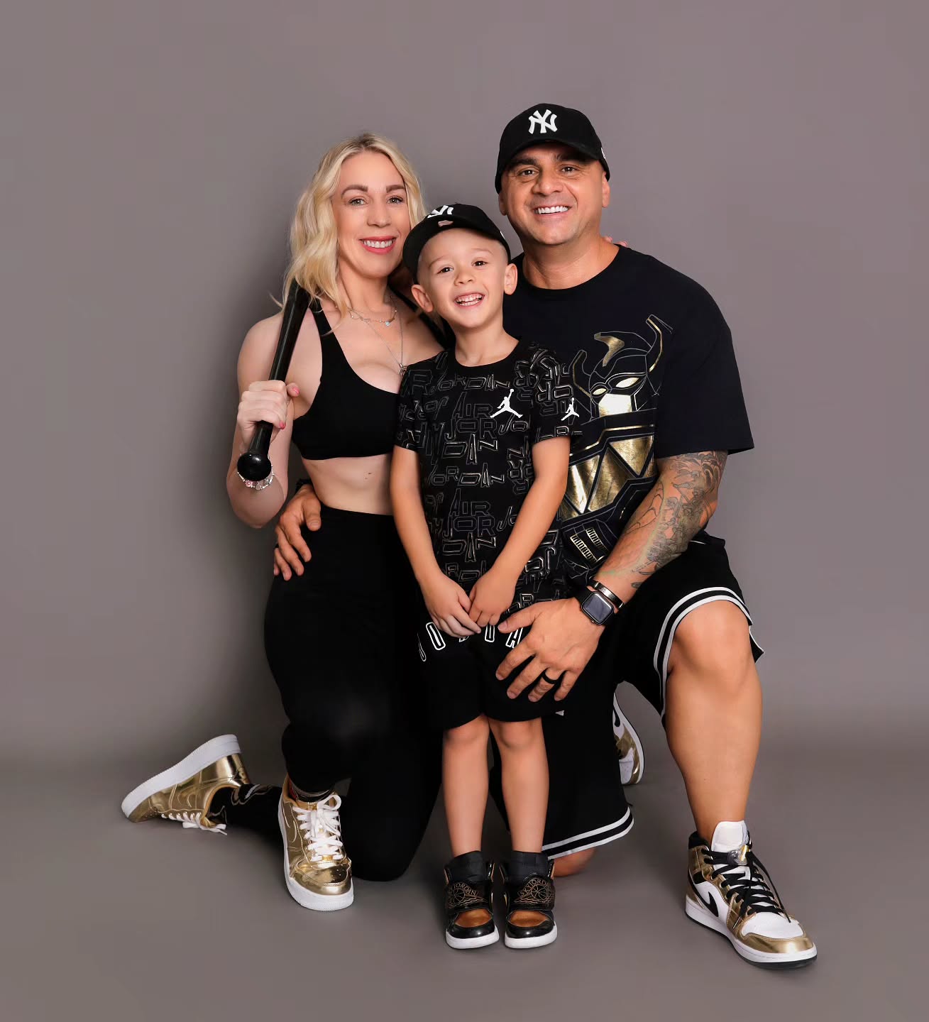 A happy family photoshoot session wearing matching outfits at Mahvin Photography in Dubai, UAE, filled with warmth and joy.
