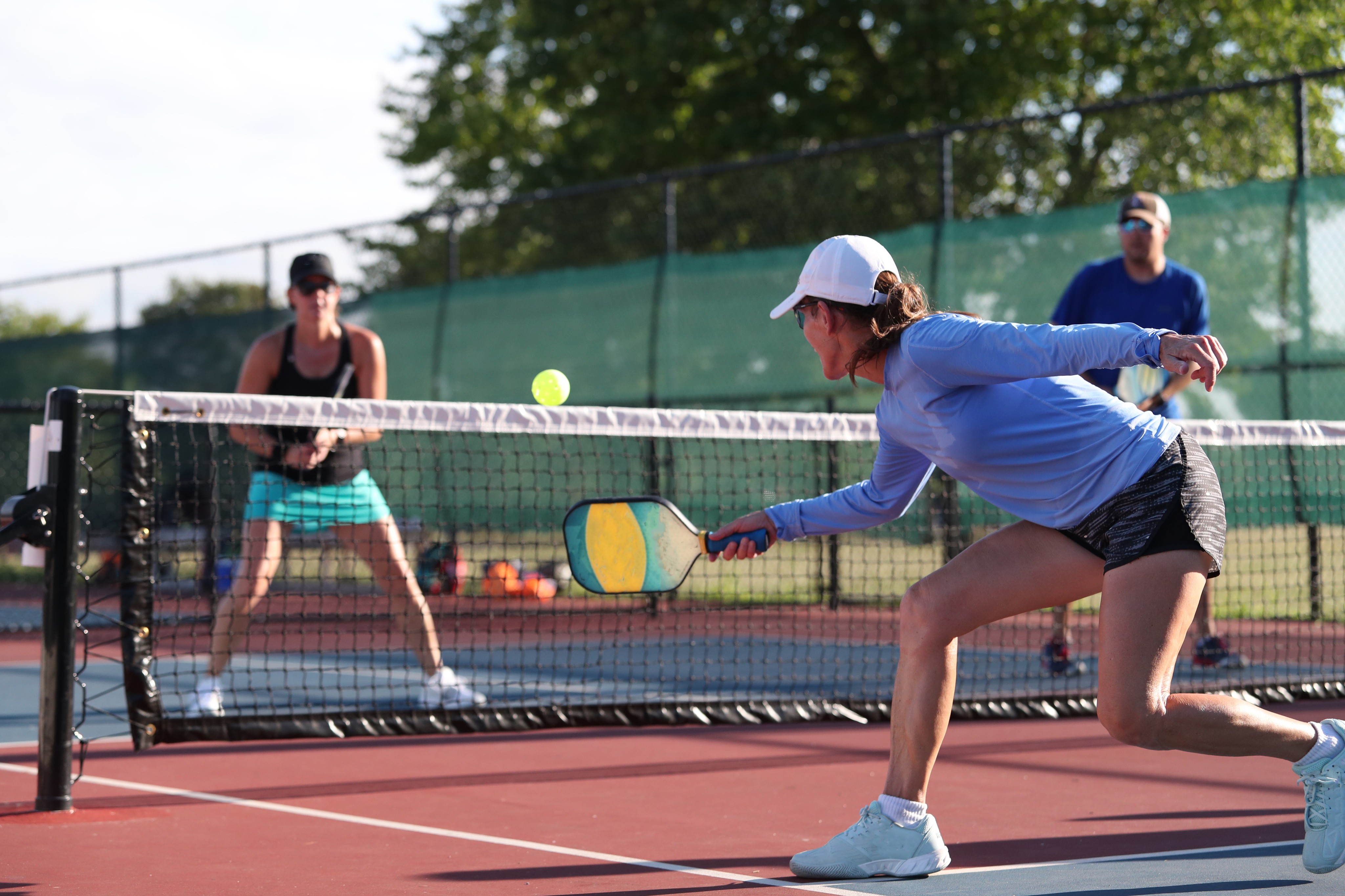 women playing pickleball