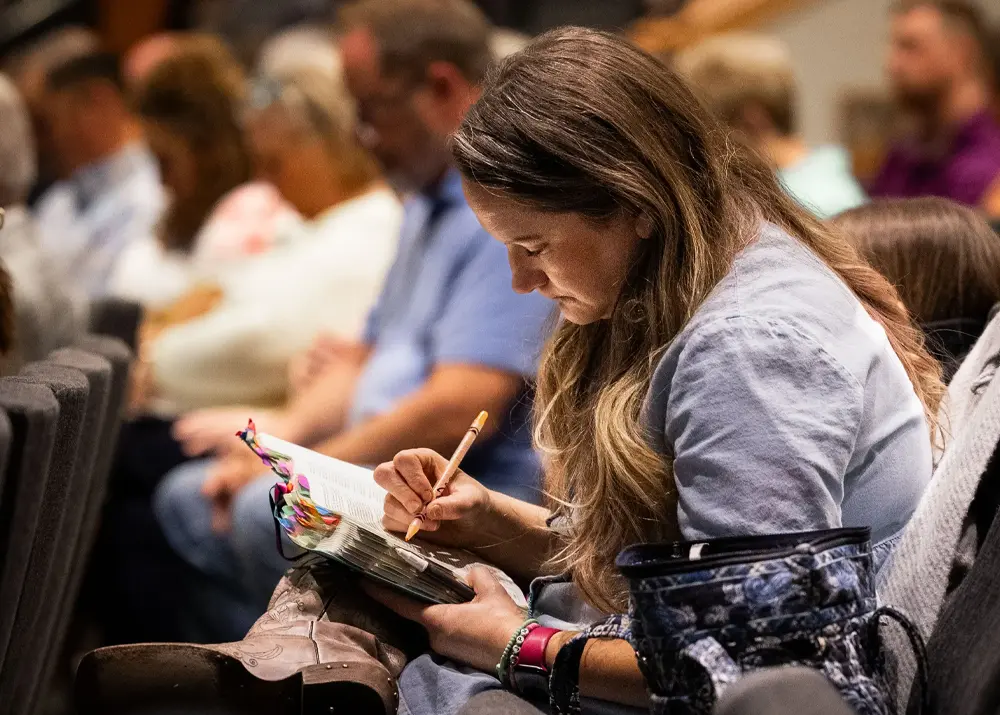 Woman taking notes during a sermon