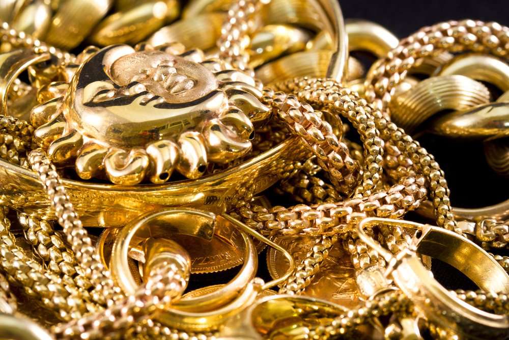 Close up of a pile of misc golden jewelry