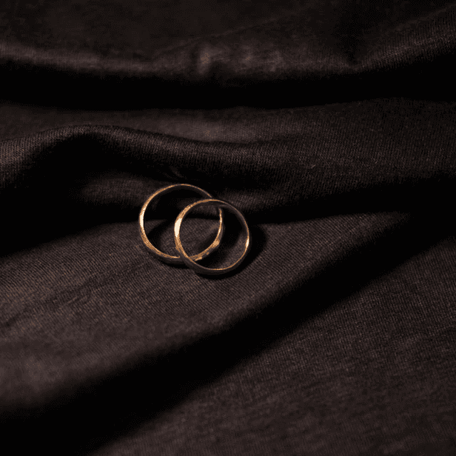 gold ring on black textile
