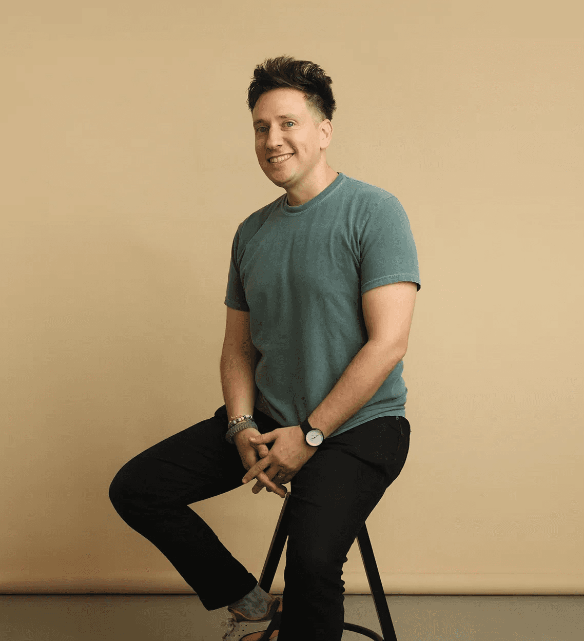 Portrait of Leadoff Studio's founder seated against a neutral backdrop